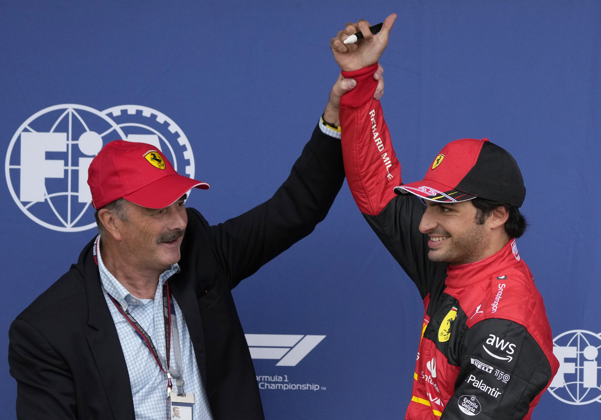 Ferrari driver lt;HIT gt;Carlos lt;/HIT gt; lt;HIT gt;Sainz lt;/HIT gt; of Spain, right, poses with former British driver Nigel Mansell after he clocked the fastest time during the qualifying session for the British Formula One Grand Prix at the Silverstone circuit, in Silverstone, England, Saturday, July 2, 2022. The British F1 Grand Prix is held on Sunday July 3, 2022. (AP Photo/Matt Dunham)