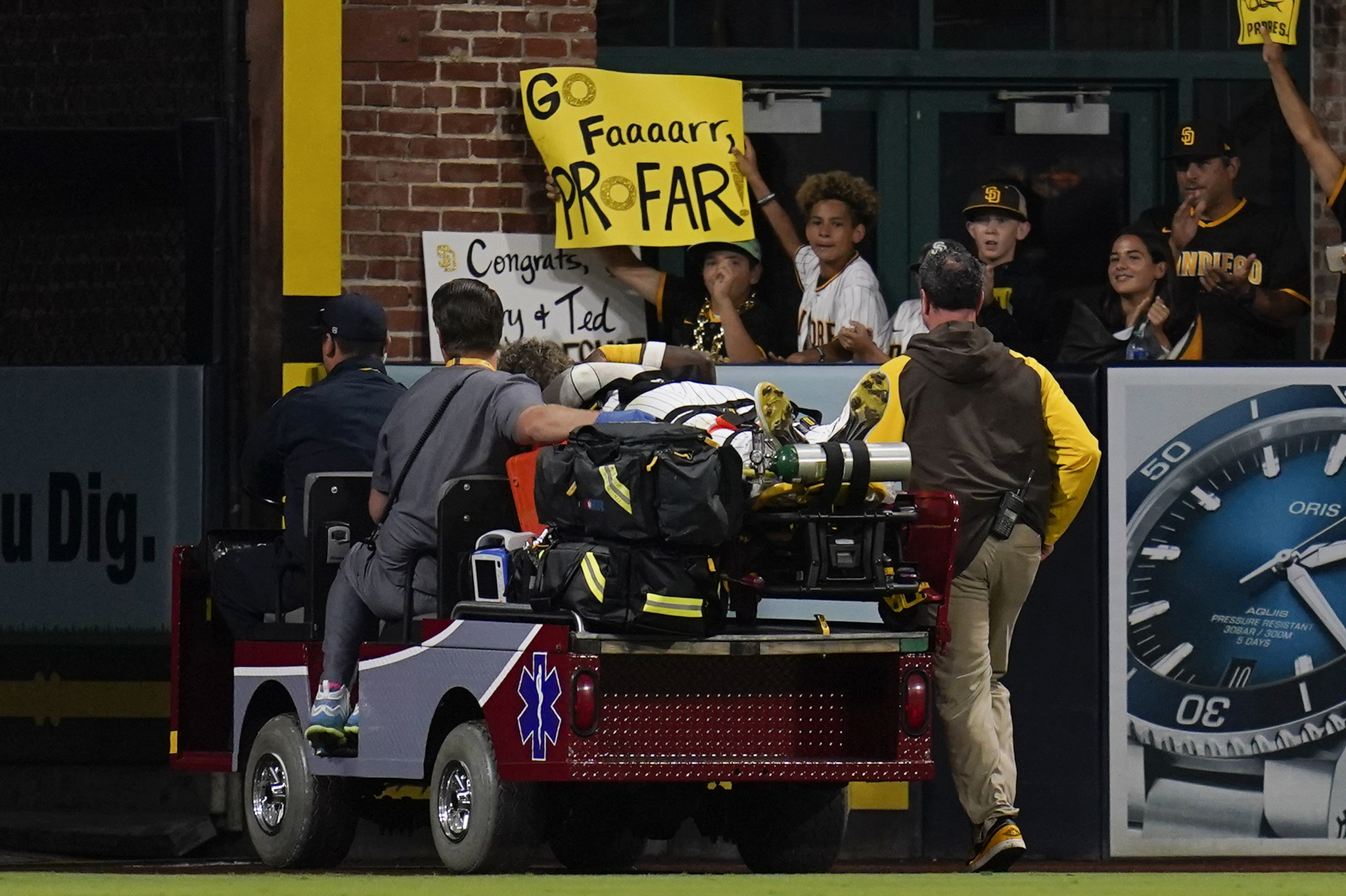 San Diego Padres left fielder Jurickson Profar leaves on a cart after colliding with shortstop C.J. Abrams