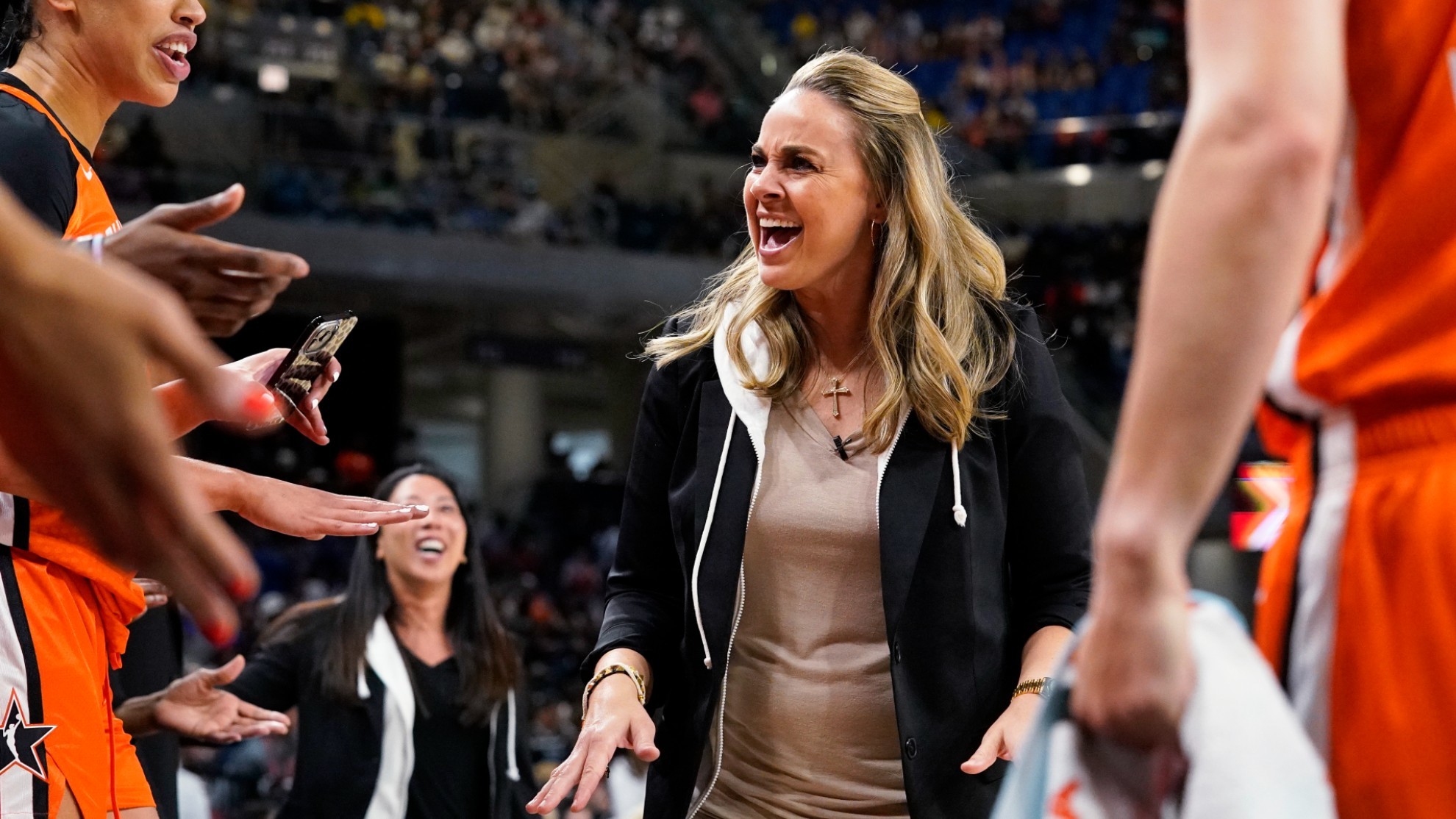 Team Wilson head coach Becky Hammon talks to players during the first half of a WNBA All-Star basketball game.