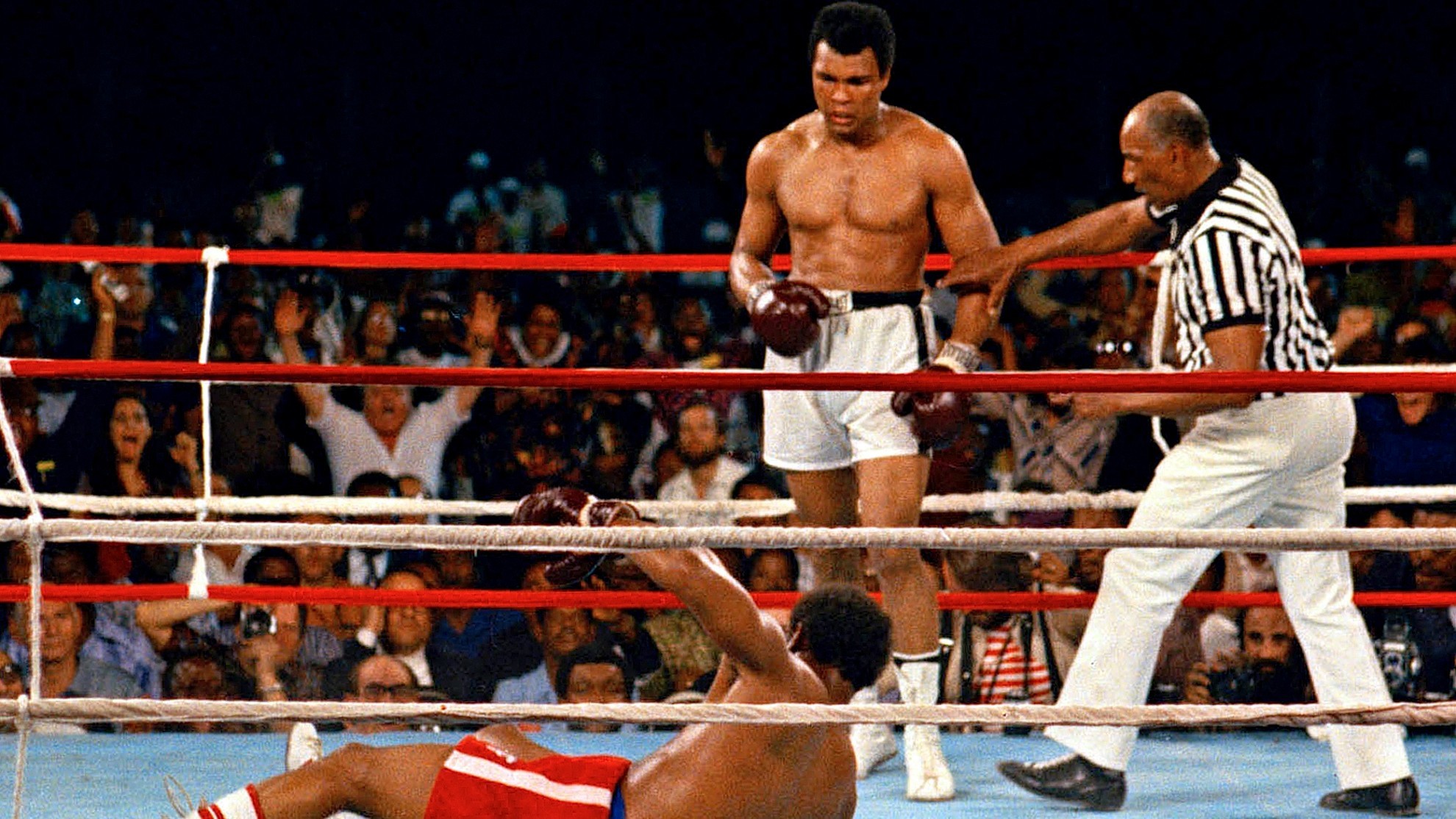 Referee Zack Clayton steps in after challenger Muhammad Ali knocked down defending heavyweight champion George Foreman.