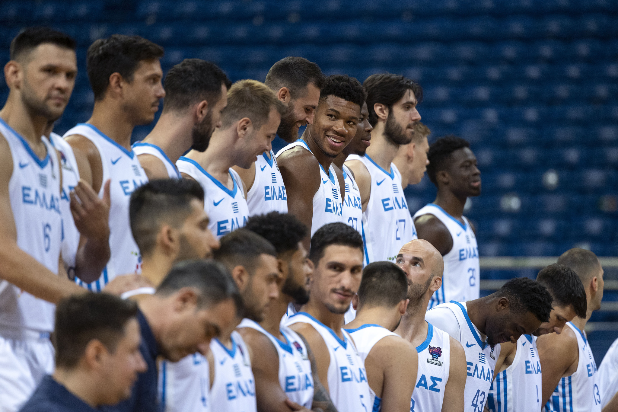 NBA basketball player  lt;HIT gt;Giannis lt;/HIT gt;  lt;HIT gt;Antetokounmpo lt;/HIT gt;, 5th right, smiles during a photo shoot of the Greek National team, in Athens, Saturday, Aug. 6, 2022. The two-time NBA MVP joined the team with his three brothers ahead of the FIBA Eurobasket 2022 event, due to start on Sept. 1. (AP Photo/Yorgos Karahalis)