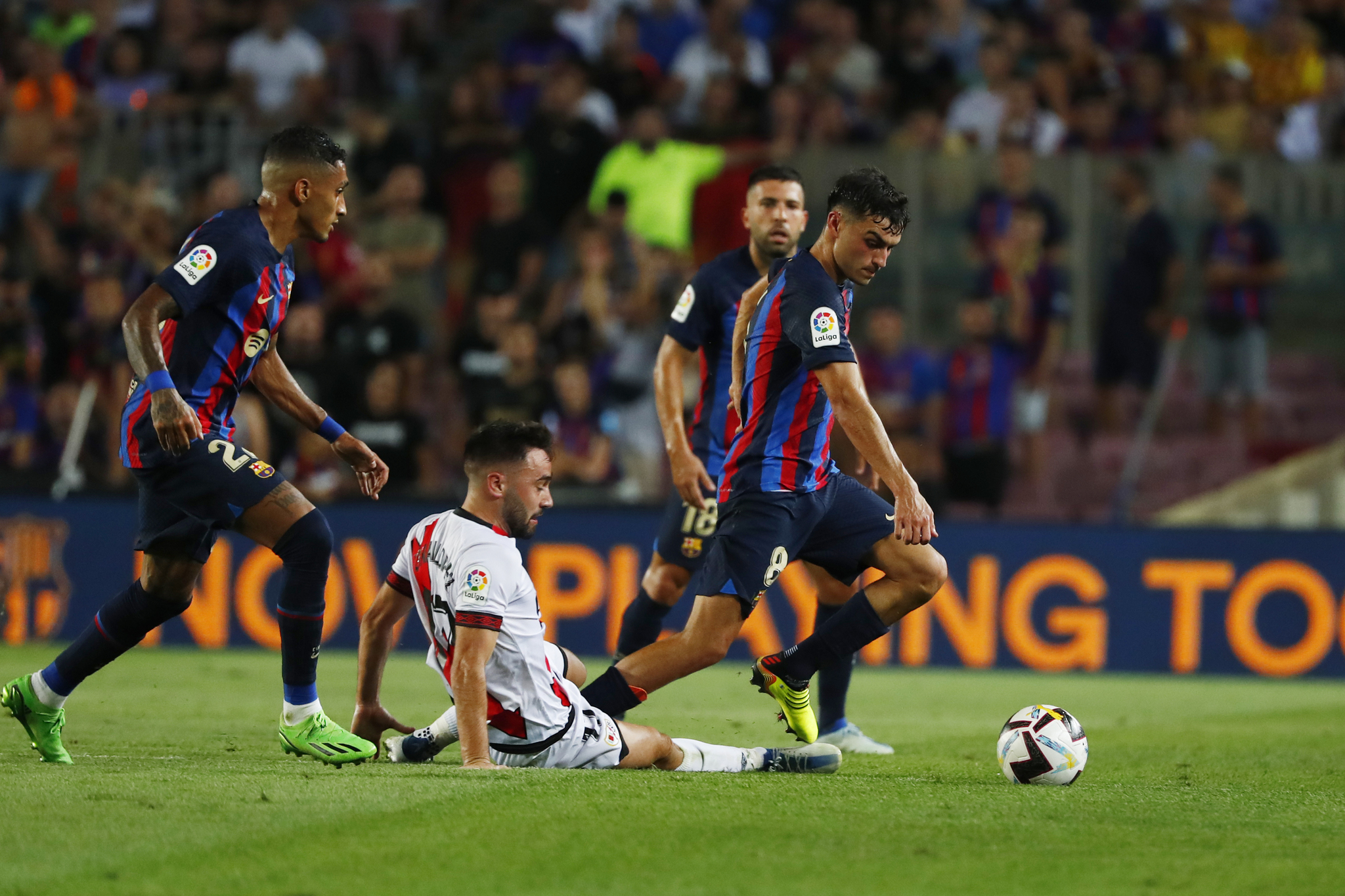 Barcelona's Pedri takes the ball past Rayo's Unai Lopez 