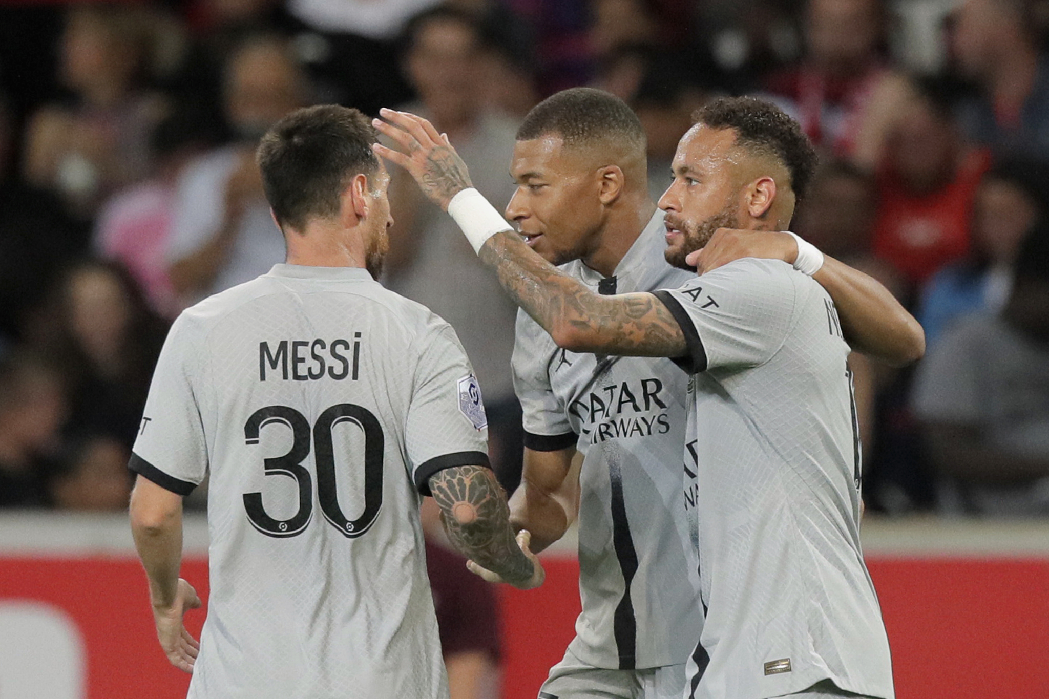 Lionel Messi, Kylia Mbappe and Neymar react after scoring a goal against Lille (AP Photo/Michel Spingler)
