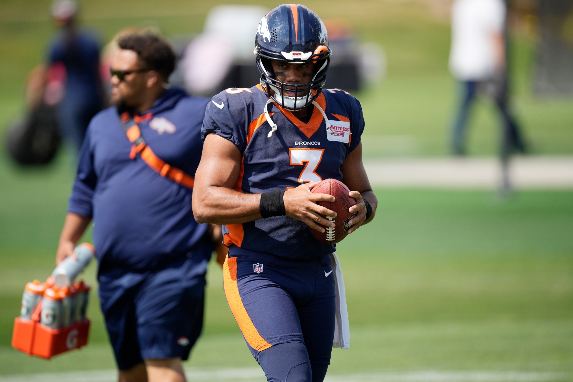 Denver Broncos quarterback Russell Wilson pauses during NFL football practice Thursday, Sept. 8, 2022, in Centennial, Colo. The Broncos open their schedule Monday night against the Seahawks in Seattle