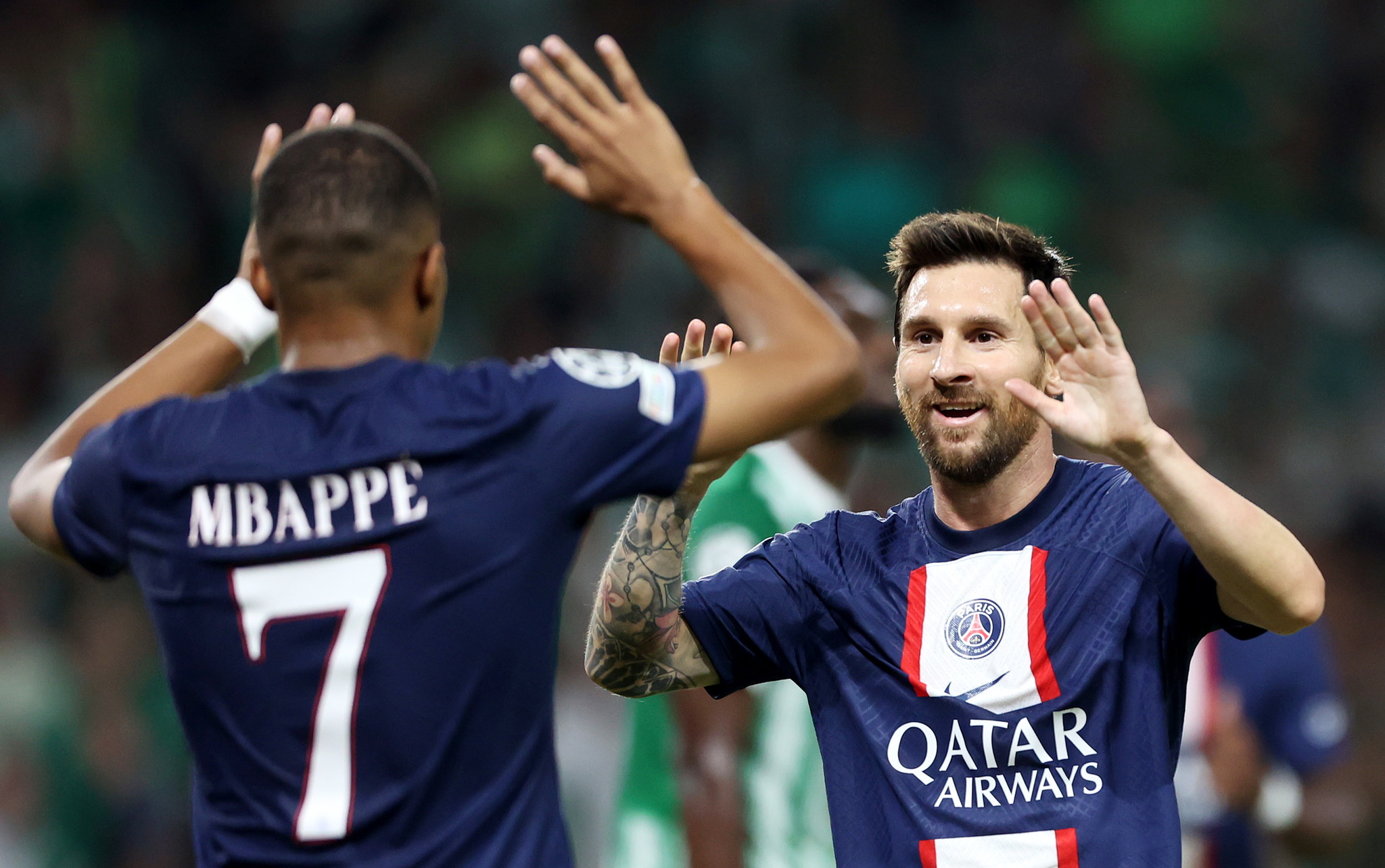 Lionel Messi celebrates with PSG teammate Kylian Mbappe