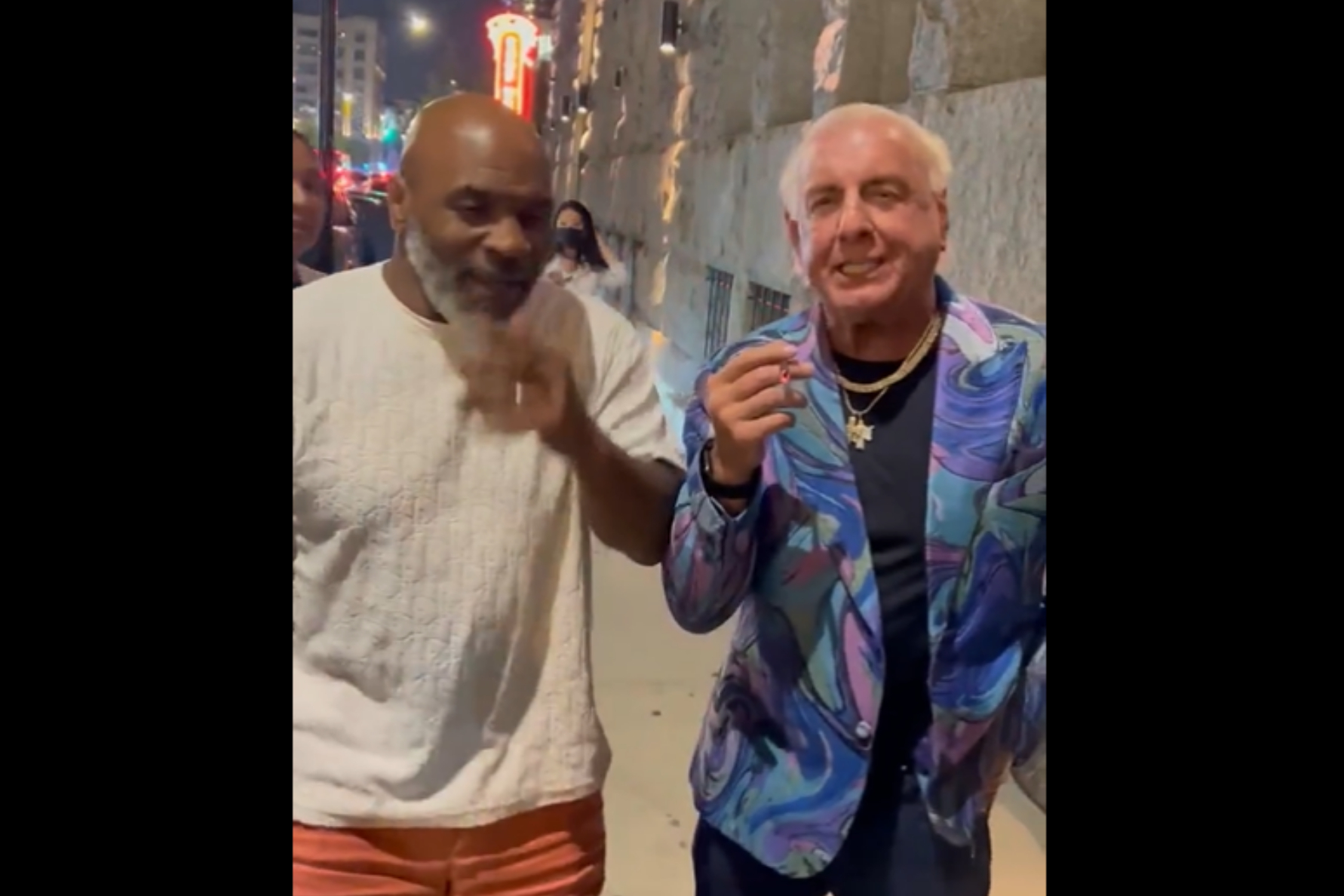 Mike Tyson and Ric Flair smoking weed on the sidewalk in Chicago. - Twitter: @RicFlairNatrBoy