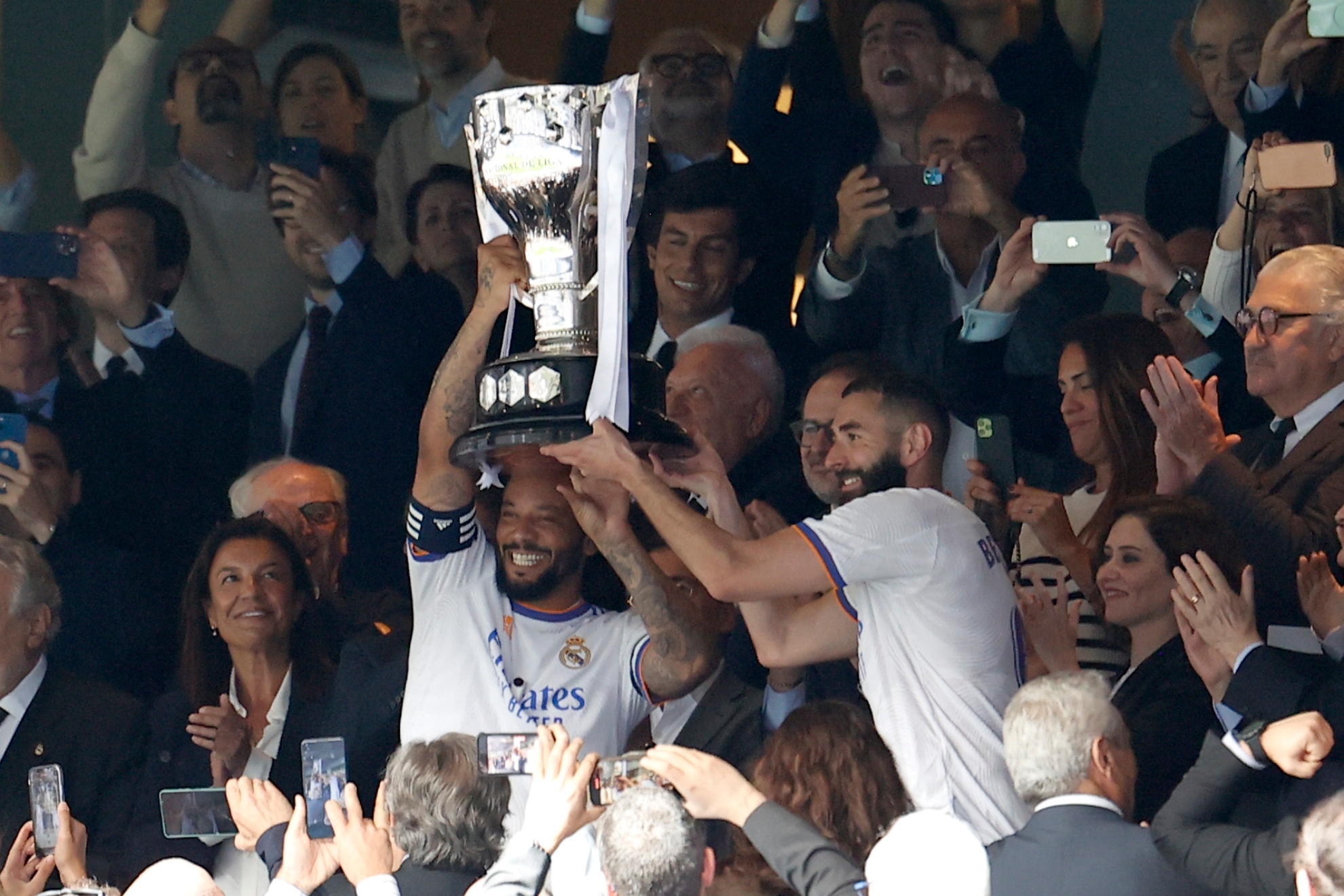 Marcelo and Benzema lift the League trophy won last season.  EFE