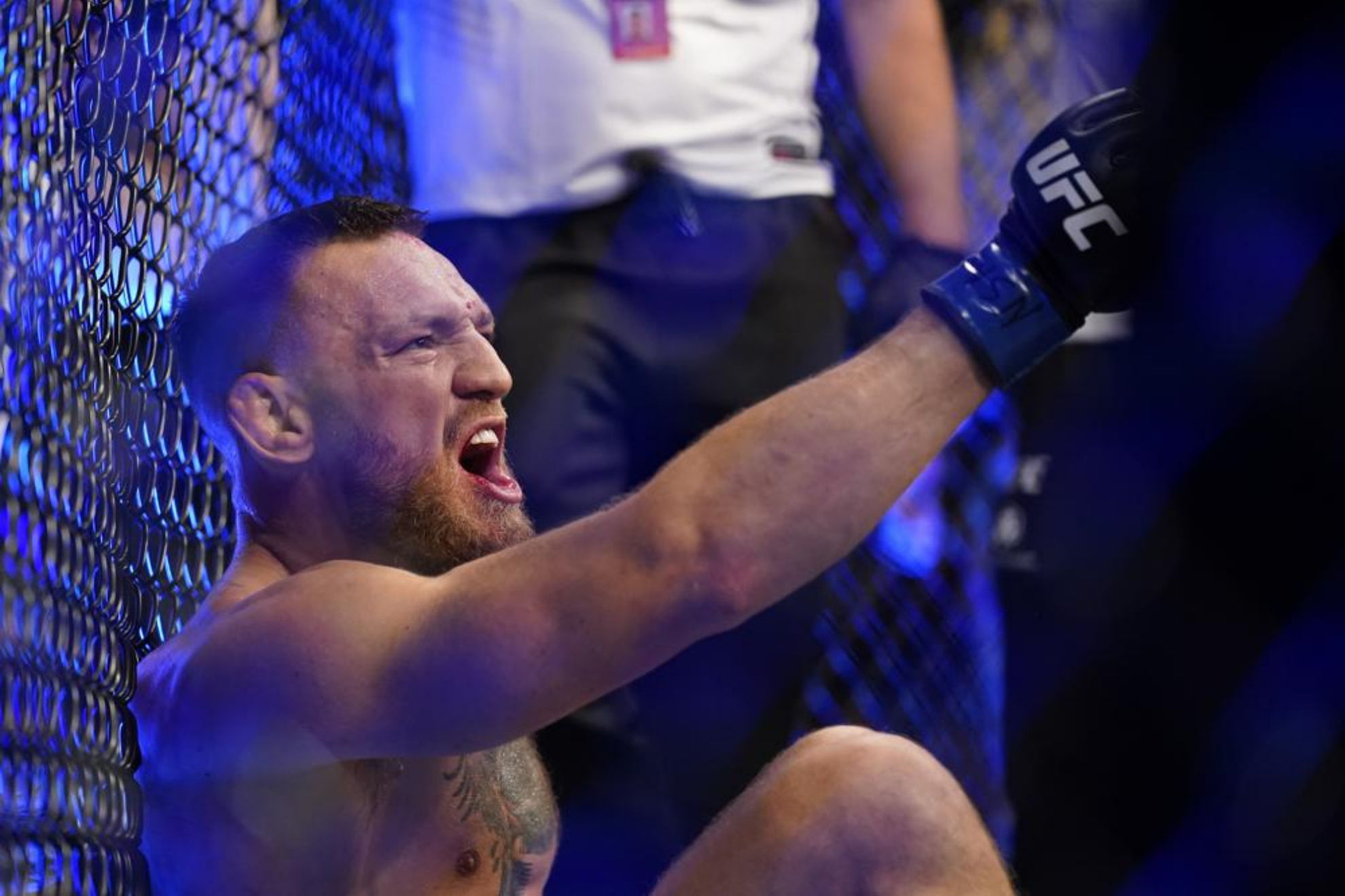 Conor McGregor yells as he sits on the mat at UFC 264. - AP Photo/John Locher