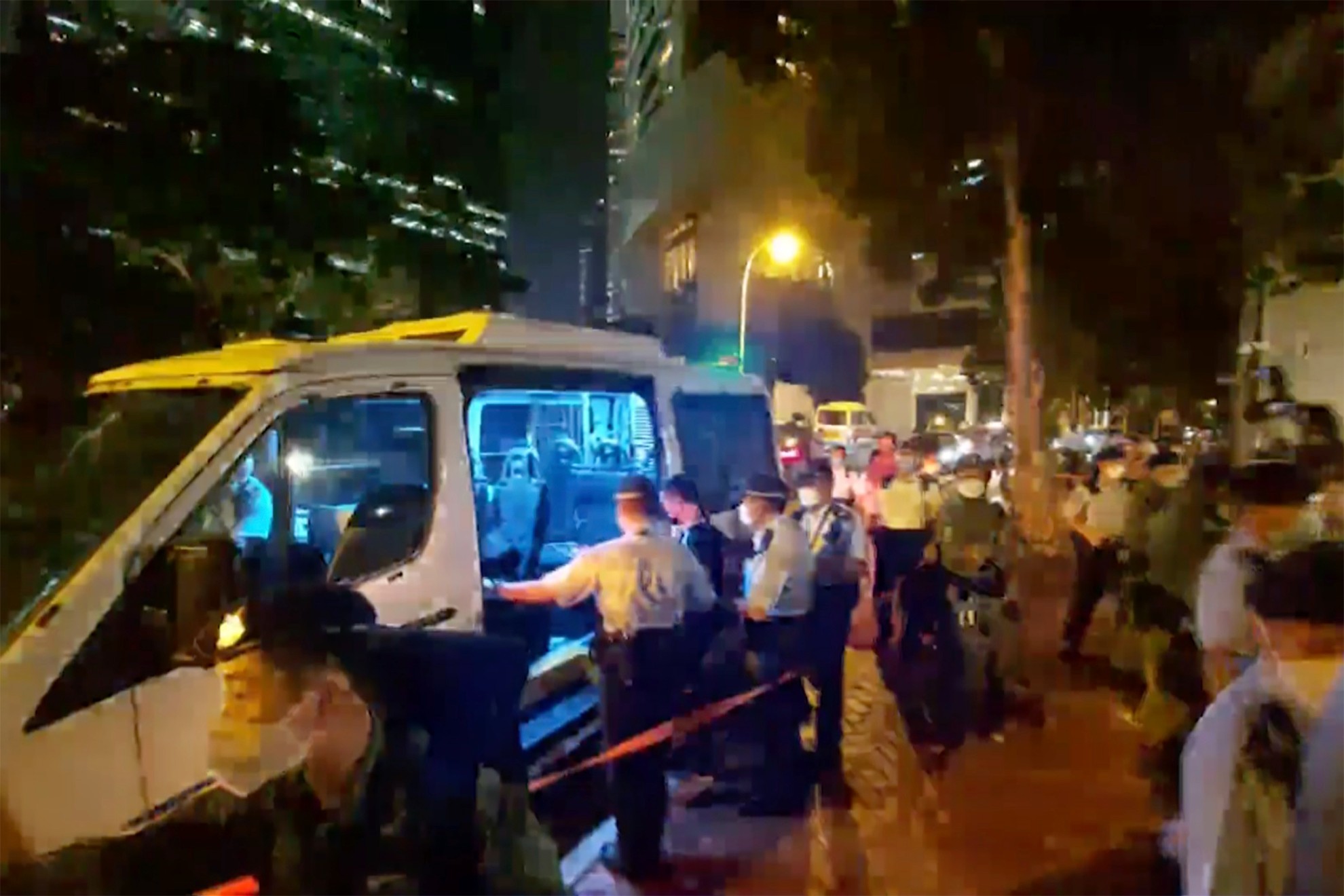 In this image police put the man, who played songs on a harmonica into police van. / AP