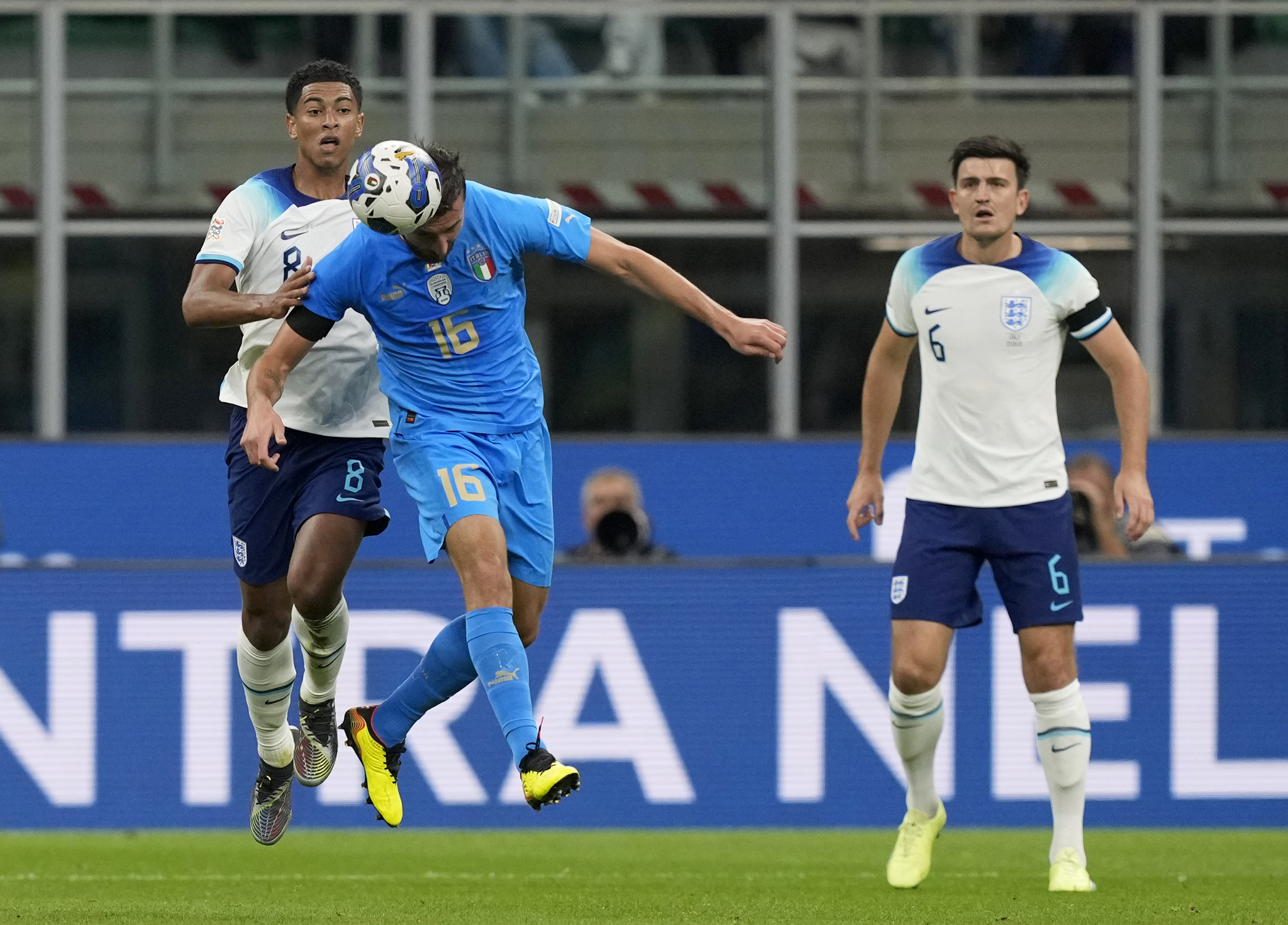 England's Jude Bellingham, left, duels for the ball with Italy's Bryan Cristante 