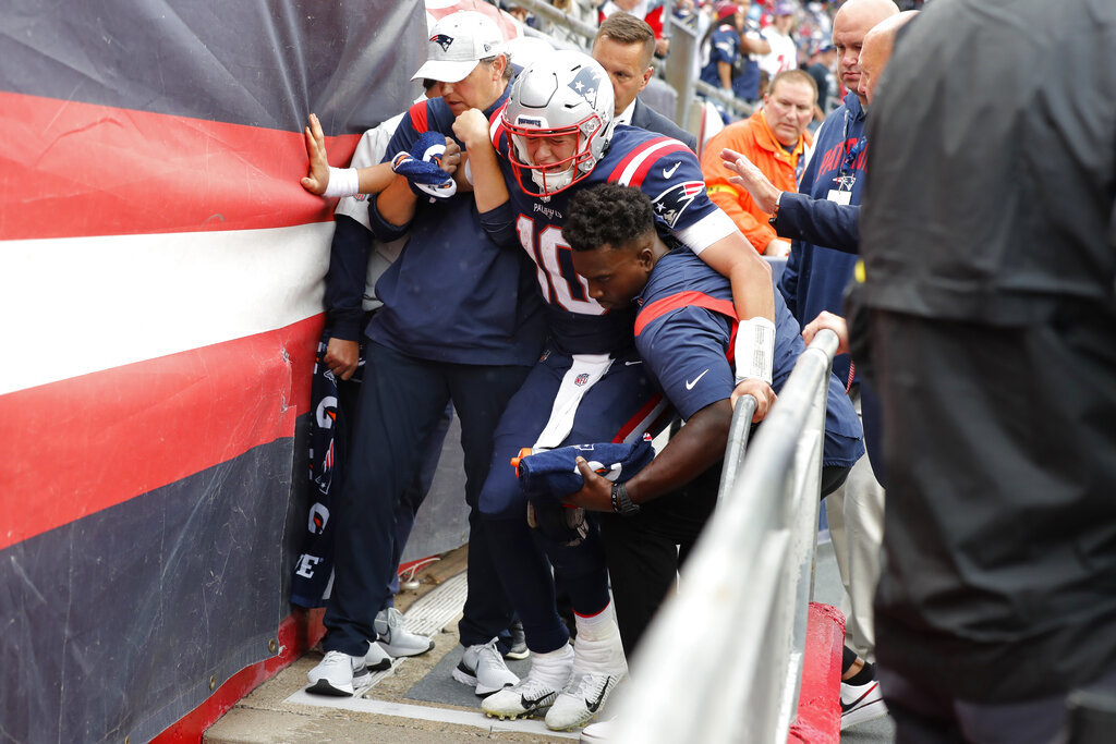 Mac Jones is helped off the field by staff after sustaining an agonizing injury. -AP