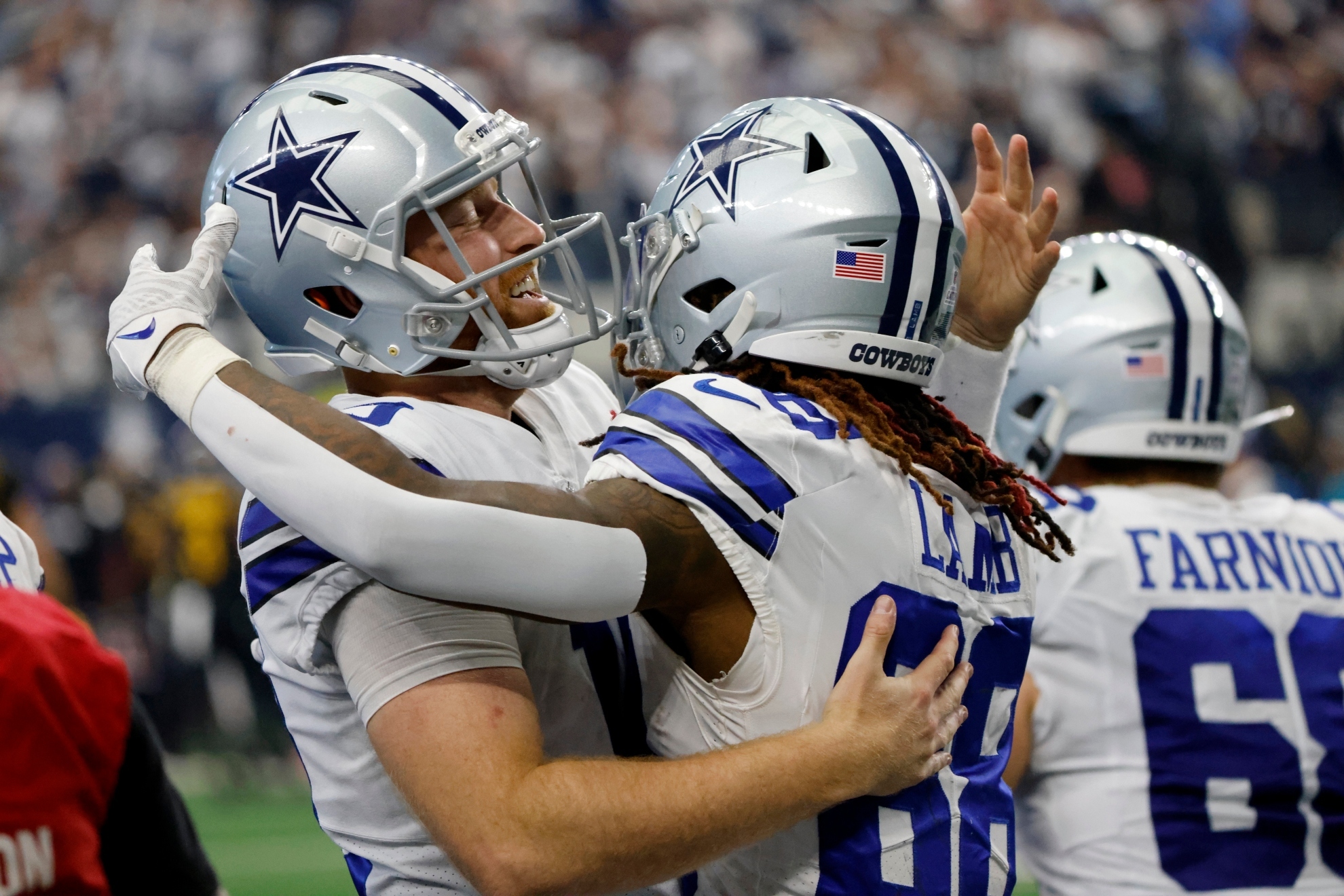 Dallas Cowboys quarterback Cooper Rush, left, and wide receiver CeeDee Lamb (88) celebrate after Rush threw a touchdown pass to Lamb in the second half of a NFL footbal l game against the Washington Commanders (AP Photo/Ron Jenkins)