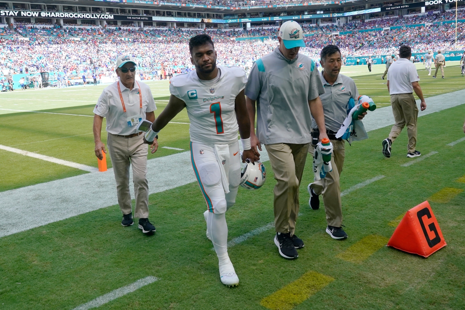 Miami Dolphins quarterback Tua Tagovailoa (1) is assisted off the field after he was injured during the first half of an NFL football game against the Buffalo Bills, Sunday, Sept. 25, 2022, in Miami Gardens, Fla / AP