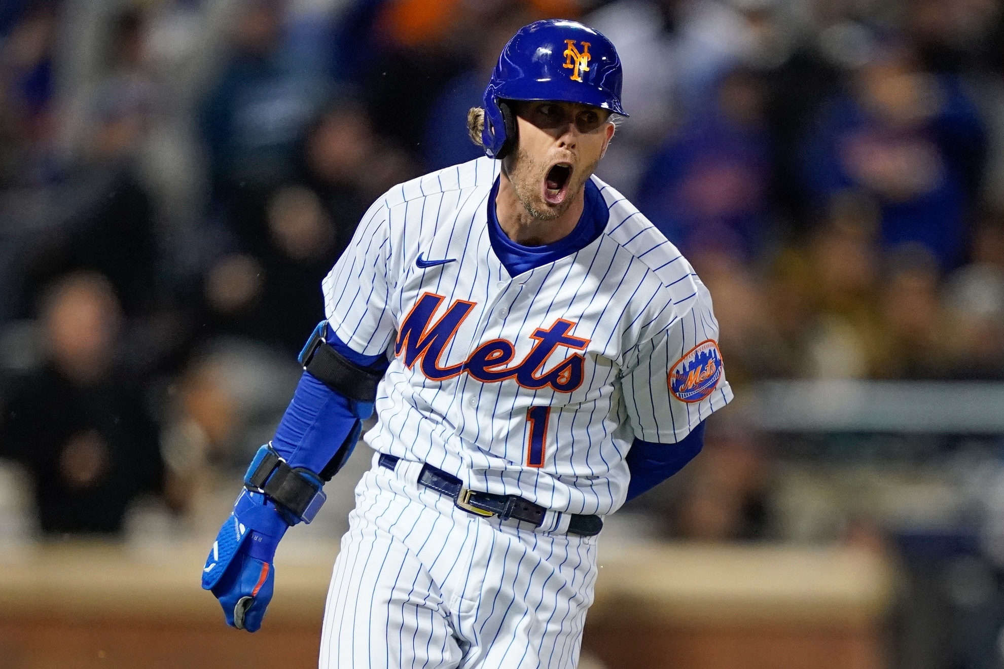 New York Mets Jeff McNeil (1) reacts as he heads up the first base line after hitting a two-run double against the San Diego Padres during the seventh inning of Game 2 of a National League wild-card baseball playoff series, Saturday, Oct. 8, 2022, in New York / AP