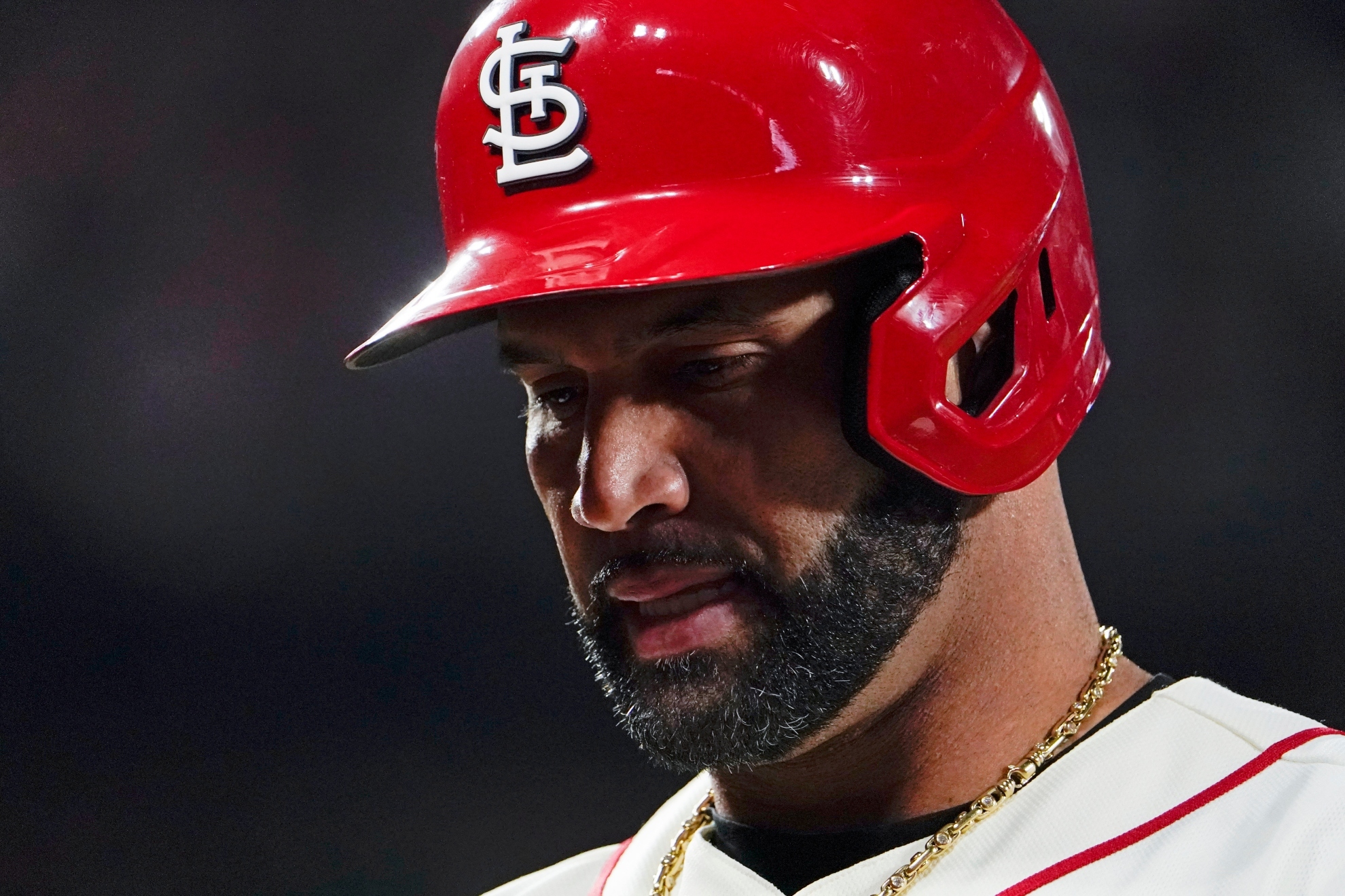 St. Louis Cardinals' Albert Pujols walks to the dugout after grounding out to Philadelphia Phillies second baseman Jean Segura during the third inning in Game 2 of an NL wild-card baseball playoff series Saturday, Oct. 8, 2022, in St. Louis / AP