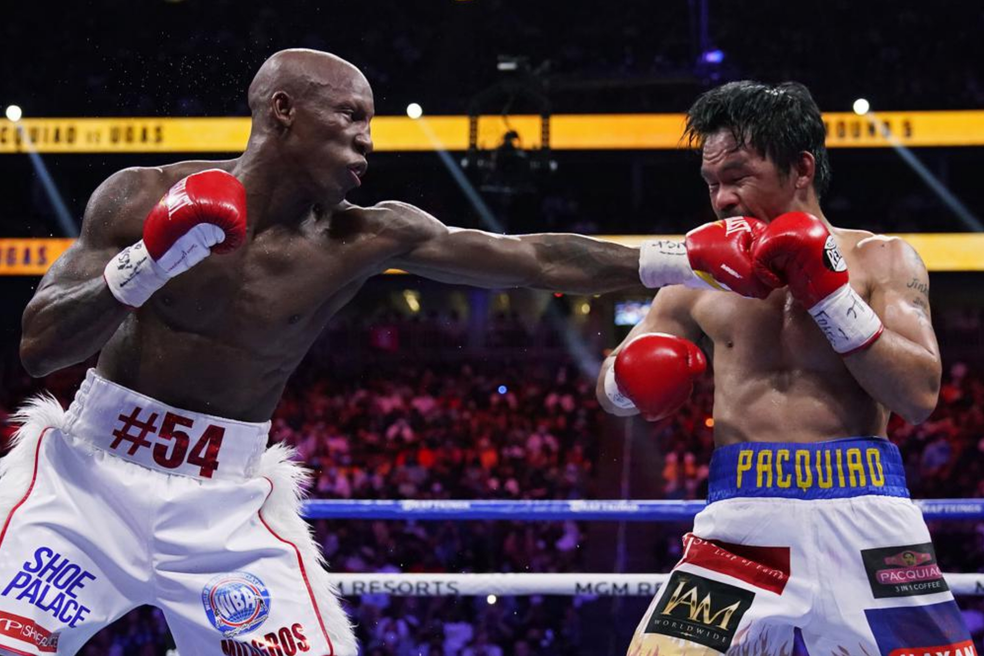 Yordenis Ugás hits Manny Pacquiao in their welterweight championship boxing bout. - AP Photo/John Locher