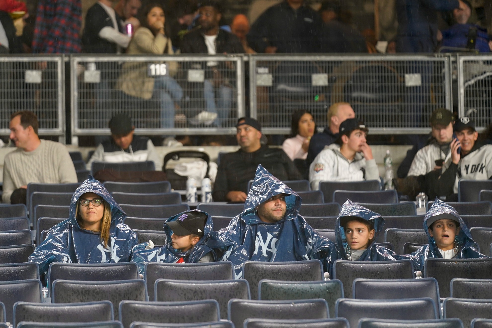 Yankees fans wait out a rain delay for Game 5 of the ALDS/AP