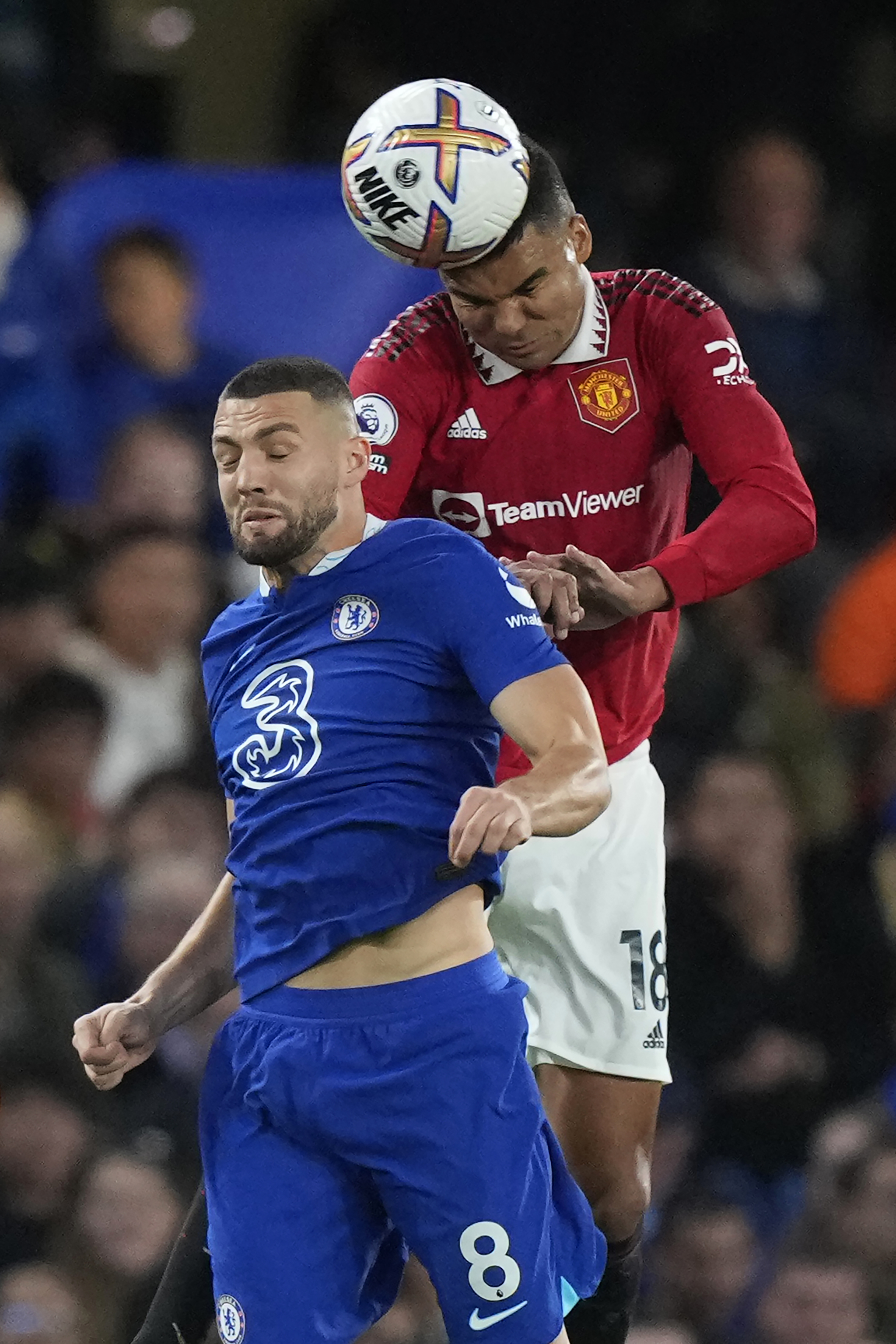 Manchester United's Casemiro, right, heads the ball over Chelsea's Mateo Kovacic