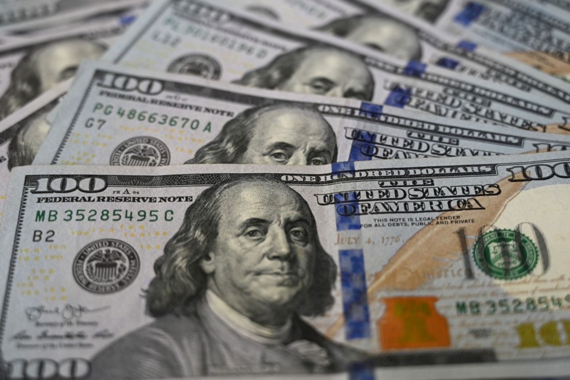 Many hundred dollar bills with Benjamin Franklin's face on them.