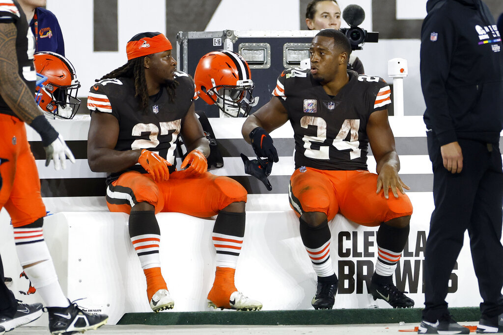 Kareem Hunt (left) sits next to starter Nick Chubb on the Cleveland Browns bench.