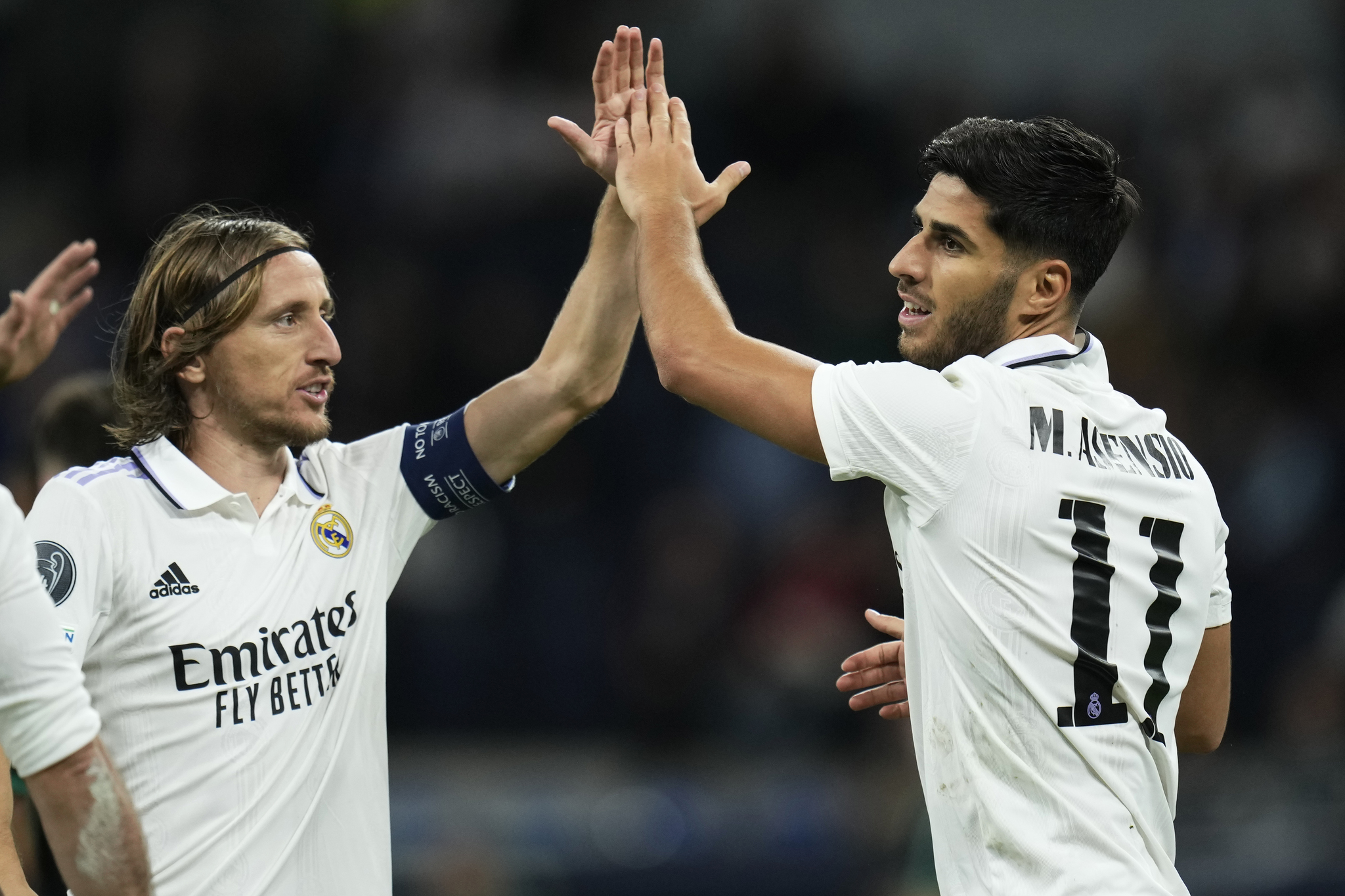 Real Madrid's Marco Asensio, right, celebrates with teammate Luka Modric after scoring
