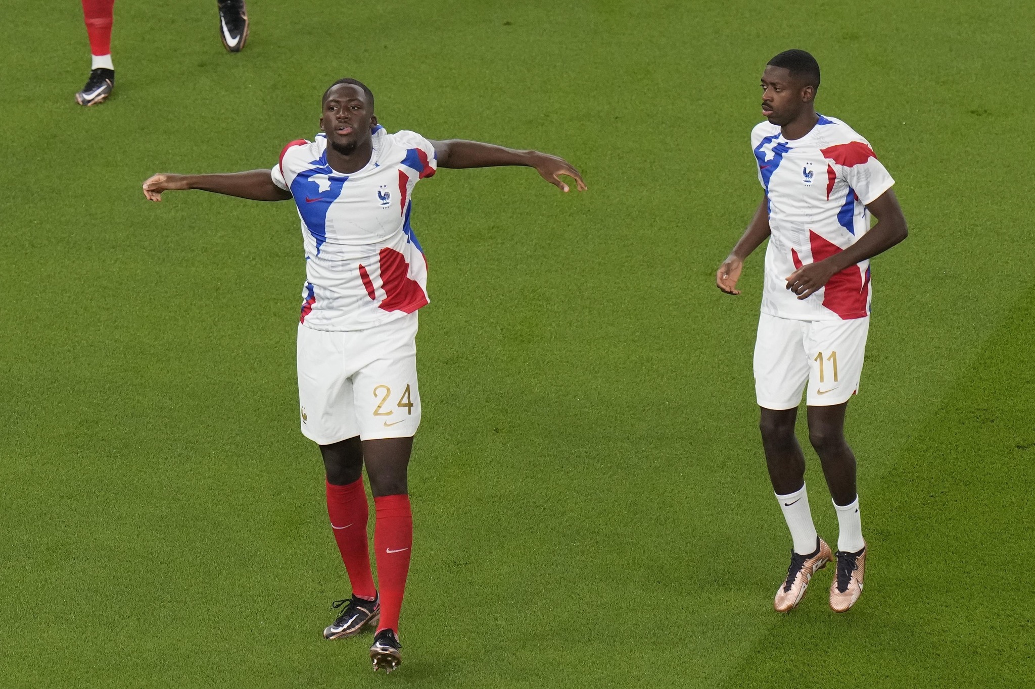 France's William Saliba, left, and France's Ousmane Dembele warm up prior to the start of the World Cup group D soccer match between France and  lt;HIT gt;Australia lt;/HIT gt;, at the Al Janoub Stadium in Al Wakrah, Qatar, Tuesday, Nov. 22, 2022. (AP Photo/Alessandra Tarantino)