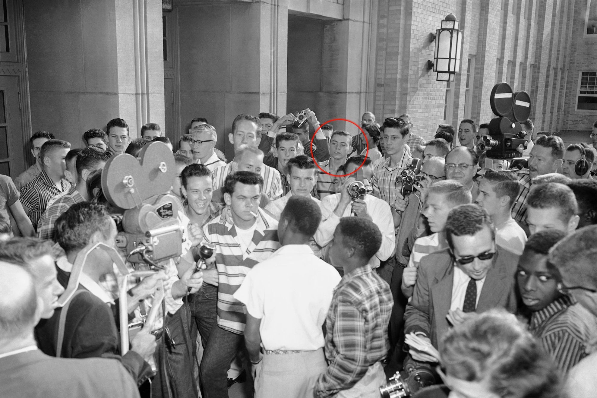 White students at Arkansas' North Little Rock High deny access to six Black students. Jerry Jones is circled.