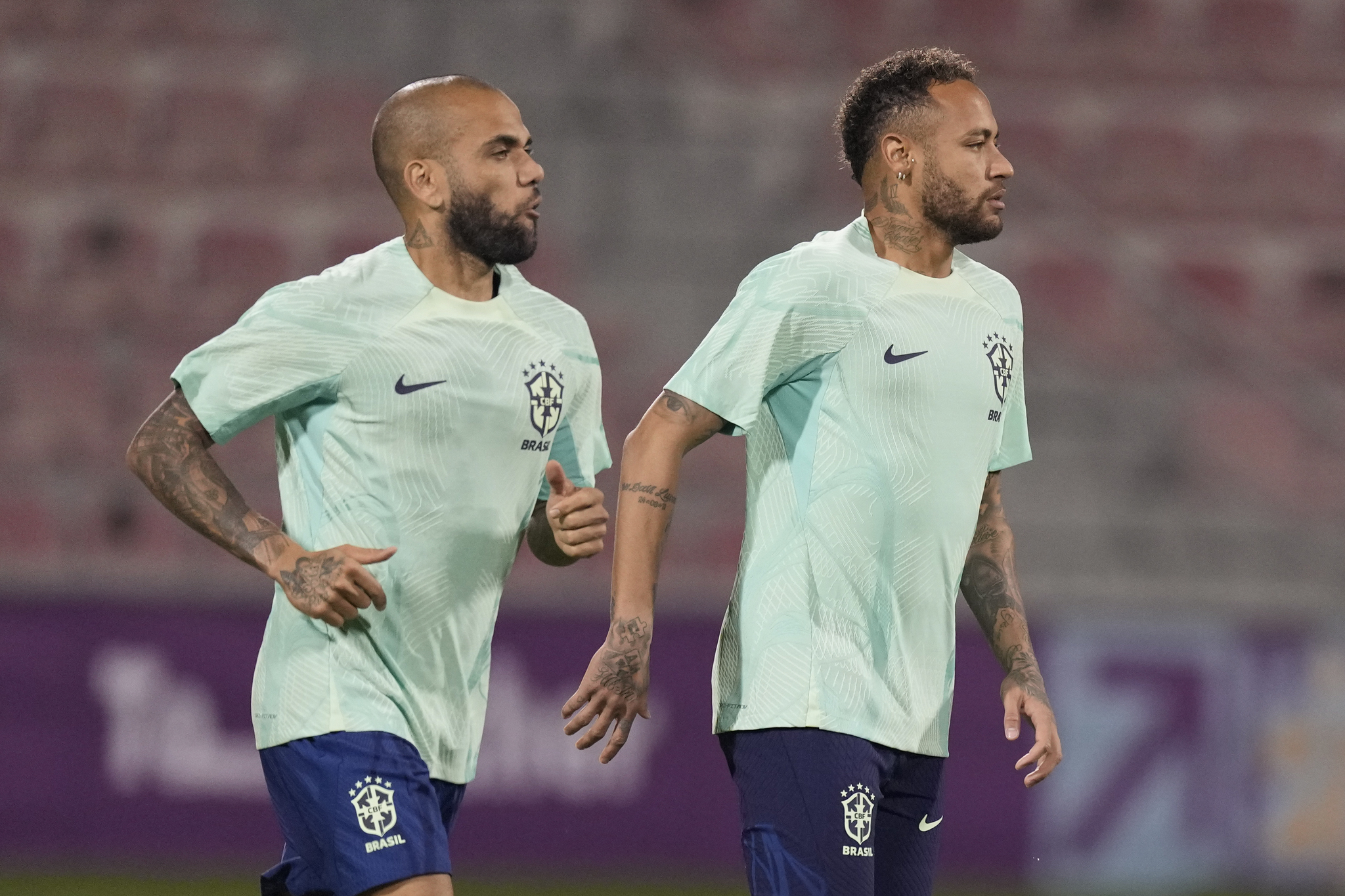 Brazil's Neymar, right, and  lt;HIT gt;Dani lt;/HIT gt;  lt;HIT gt;Alves lt;/HIT gt; attend a training session at the Grand Hamad stadium, in Doha, Qatar, Wednesday, Nov. 23, 2022. Brazil will play their first match in the World Cup against Serbia on Nov. 24. (AP Photo/Andre Penner)