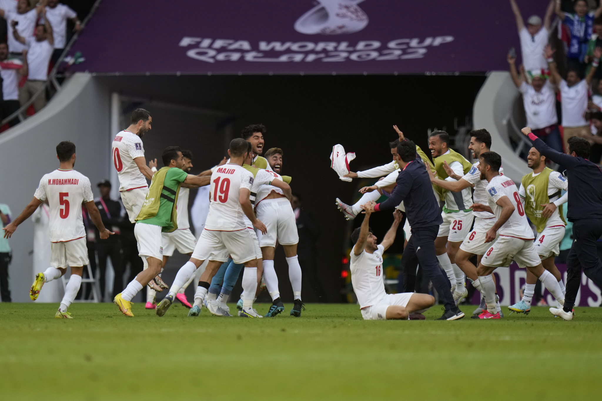 Players of team  lt;HIT gt;Iran lt;/HIT gt; celebrate after their win in the  lt;HIT gt;World lt;/HIT gt;  lt;HIT gt;Cup lt;/HIT gt; group B soccer match between Wales and  lt;HIT gt;Iran lt;/HIT gt;, at the Ahmad Bin Ali Stadium in Al Rayyan , Qatar, Friday, Nov. 25, 2022. (AP Photo/Alessandra Tarantino)