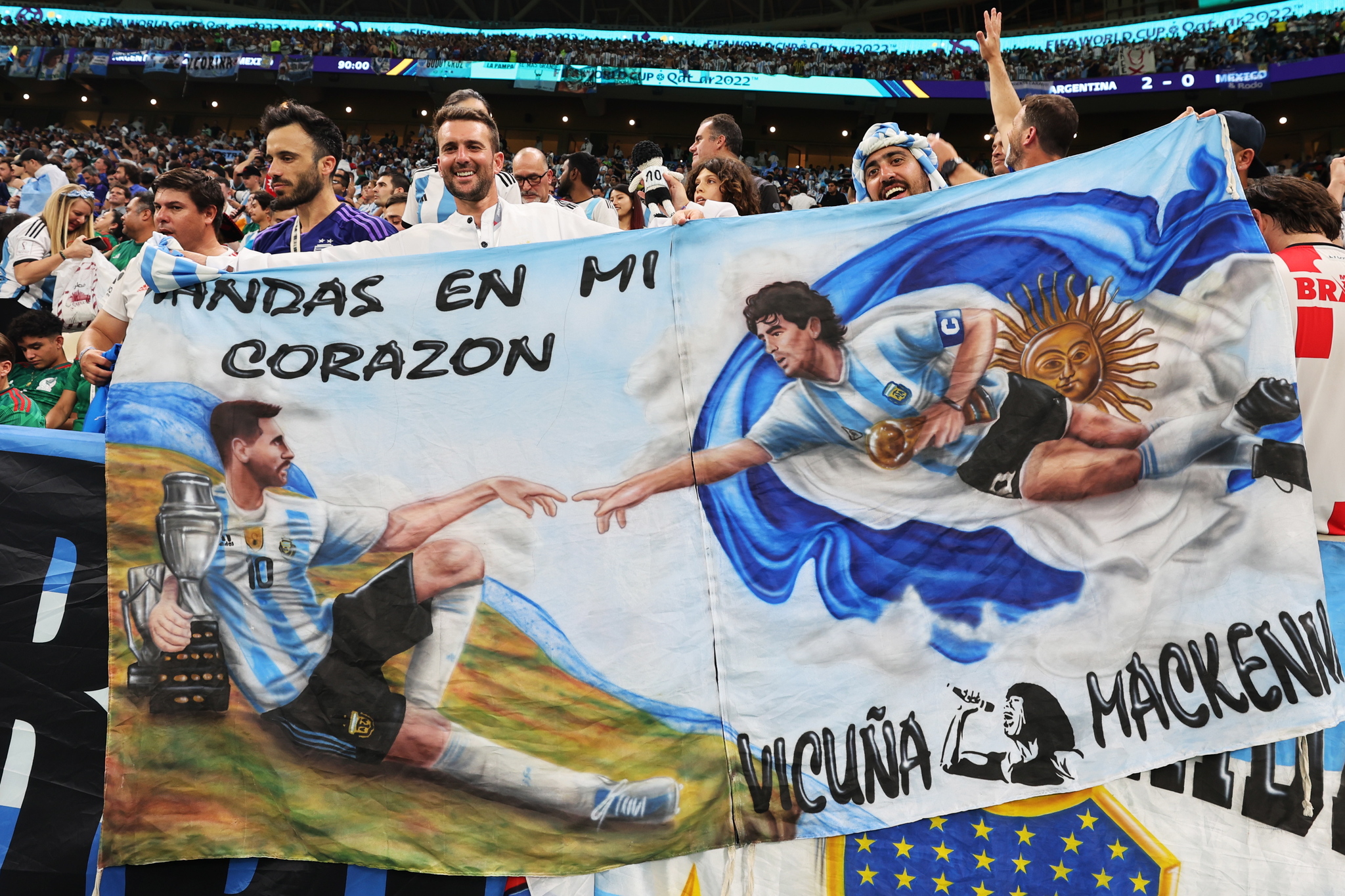 Lusail (Qatar), 26/11/2022.-  lt;HIT gt;Fans lt;/HIT gt; of  lt;HIT gt;Argentina lt;/HIT gt; hold a banner depicting Lionel Messi (L) and Diego Maradona (R) in the manner of Michelangelo's painting 'The Creation of Adam' during the FIFA World Cup 2022 group C soccer match between  lt;HIT gt;Argentina lt;/HIT gt; and Mexico at Lusail Stadium in Lusail, Qatar, 26 November 2022. (Mundial de Fútbol, Estados Unidos, Catar) EFE/EPA/Mohamed Messara