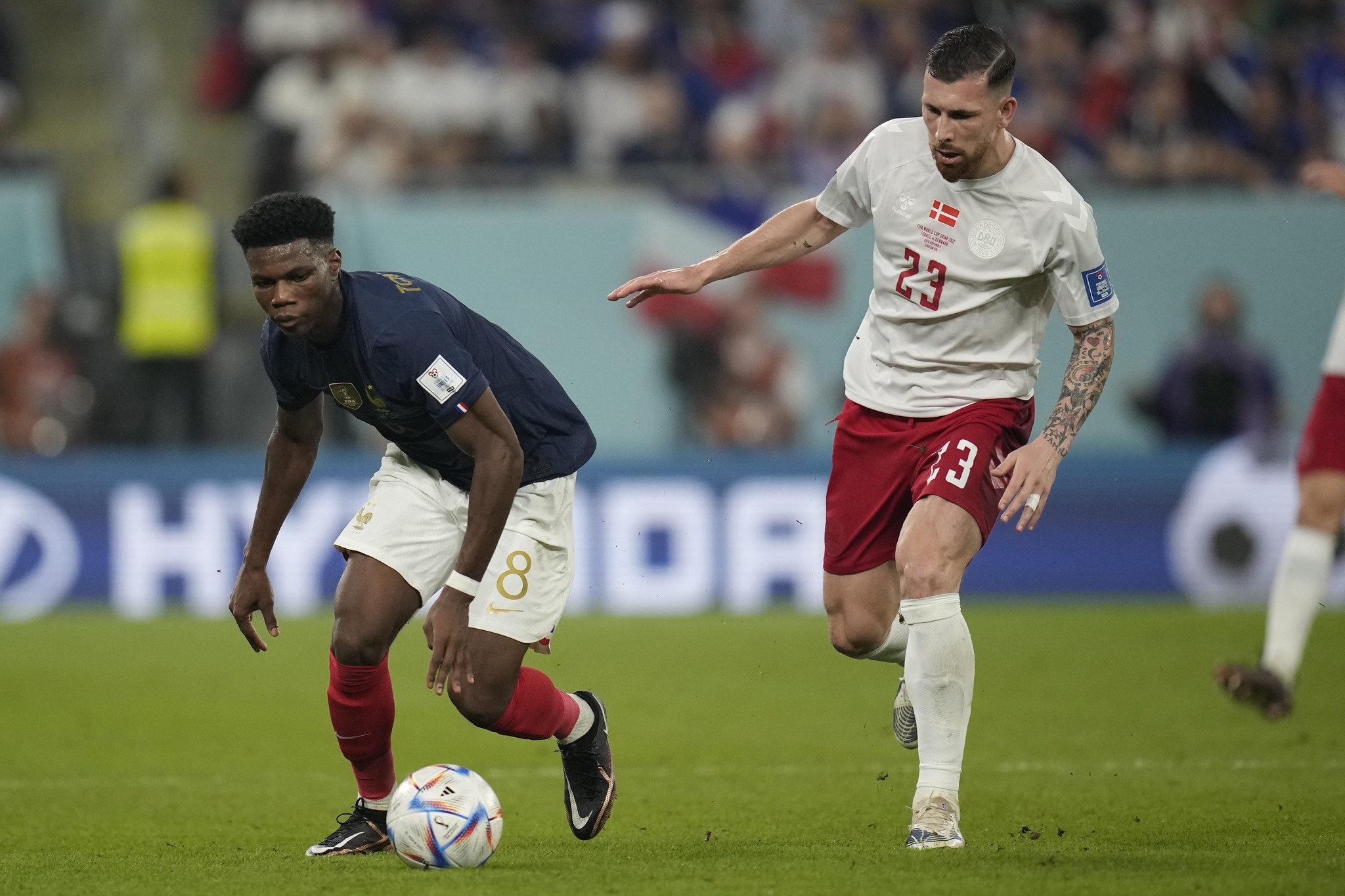 France's Aurelien  lt;HIT gt;Tchouameni lt;/HIT gt;, left, competes for the ball with Denmark's Pierre-Emile Hojbjerg during the World Cup group D soccer match between France and Denmark, at the Stadium 974 in Doha, Qatar, Saturday, Nov. 26, 2022. (AP Photo/Christophe Ena)