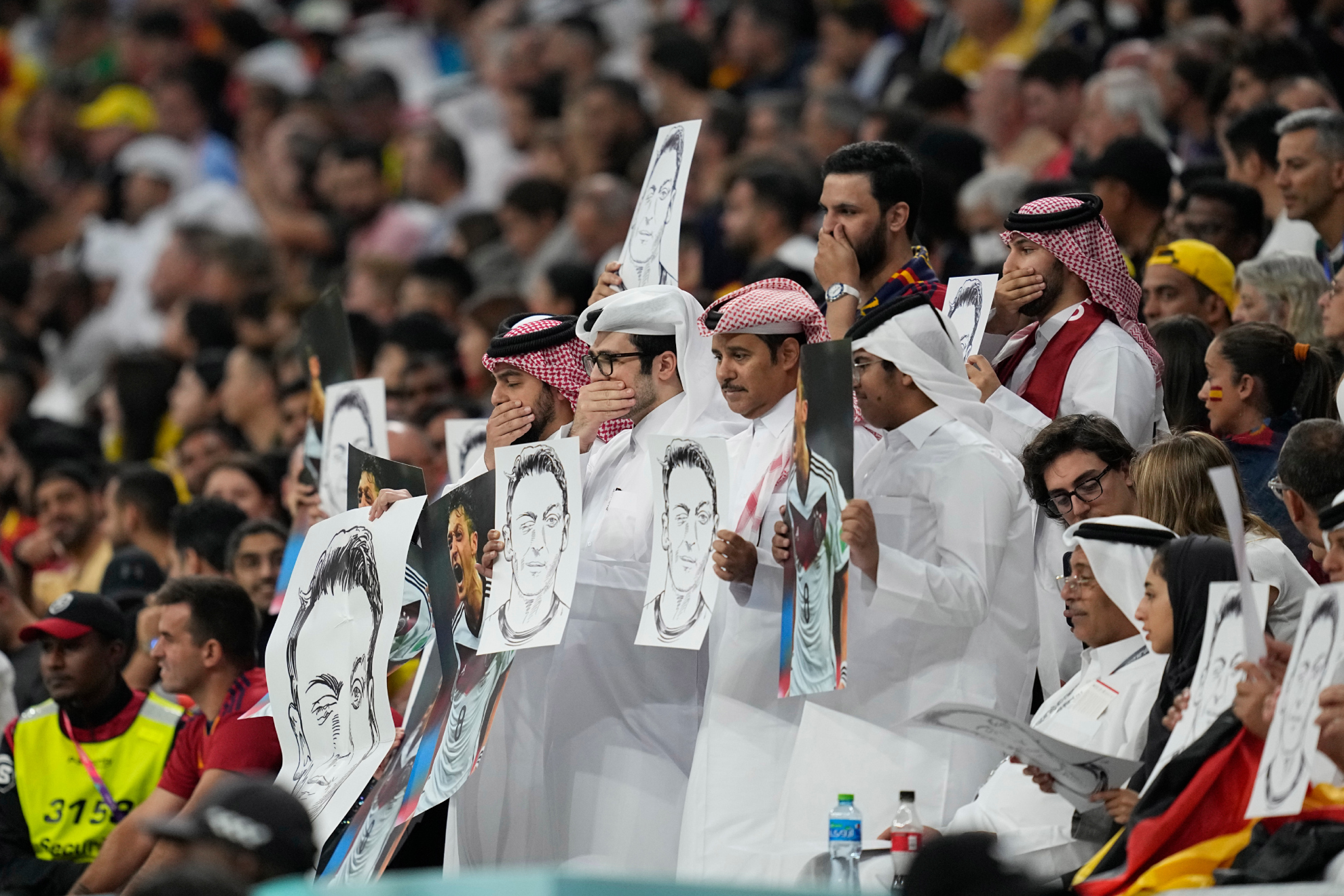 Qatar fans with images of Ozil during Spain vs Germany