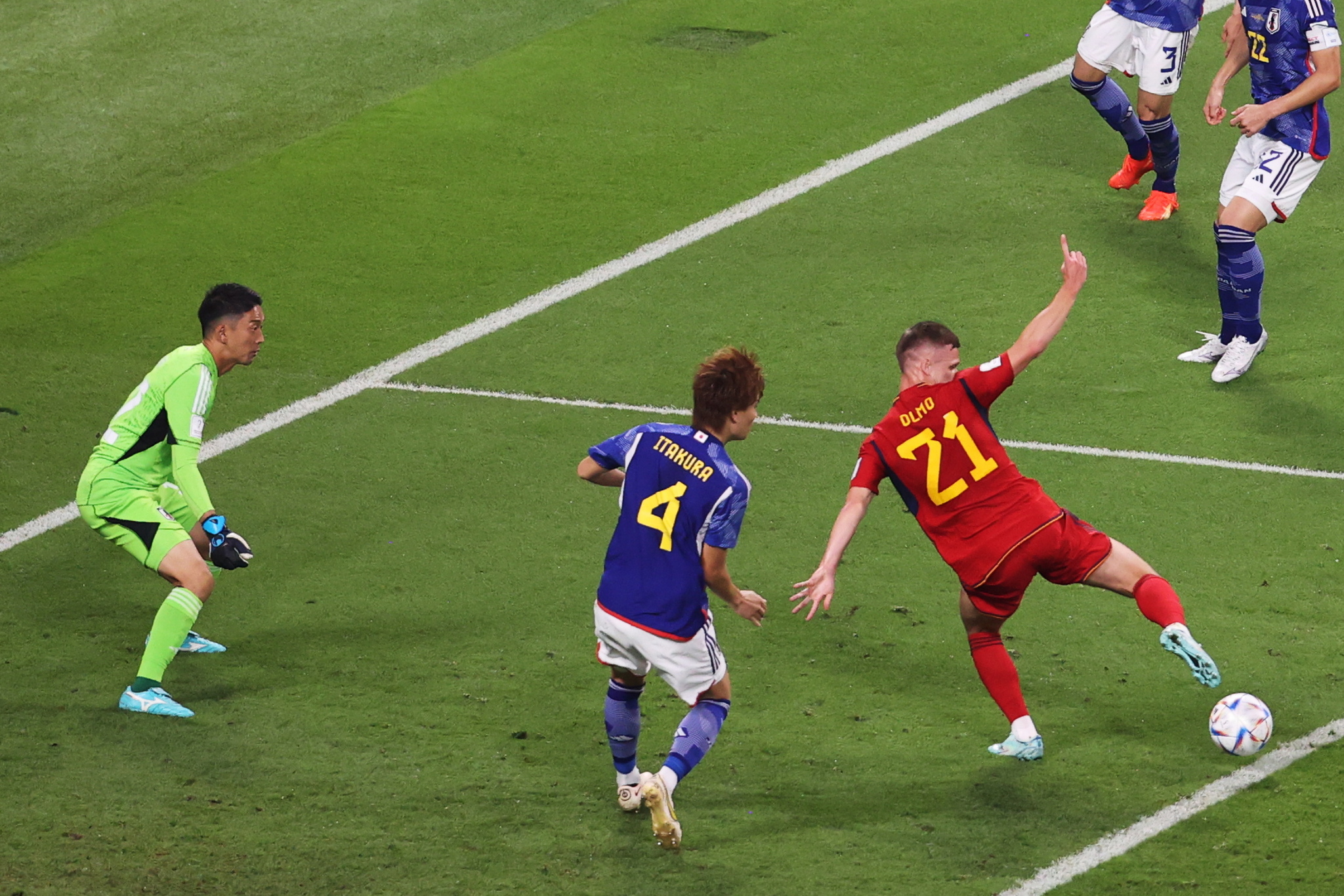 Dani Olmo of Spain (R) in action against Ko Itakura (C) and goalkeeper Shuichi Gonda of Japan