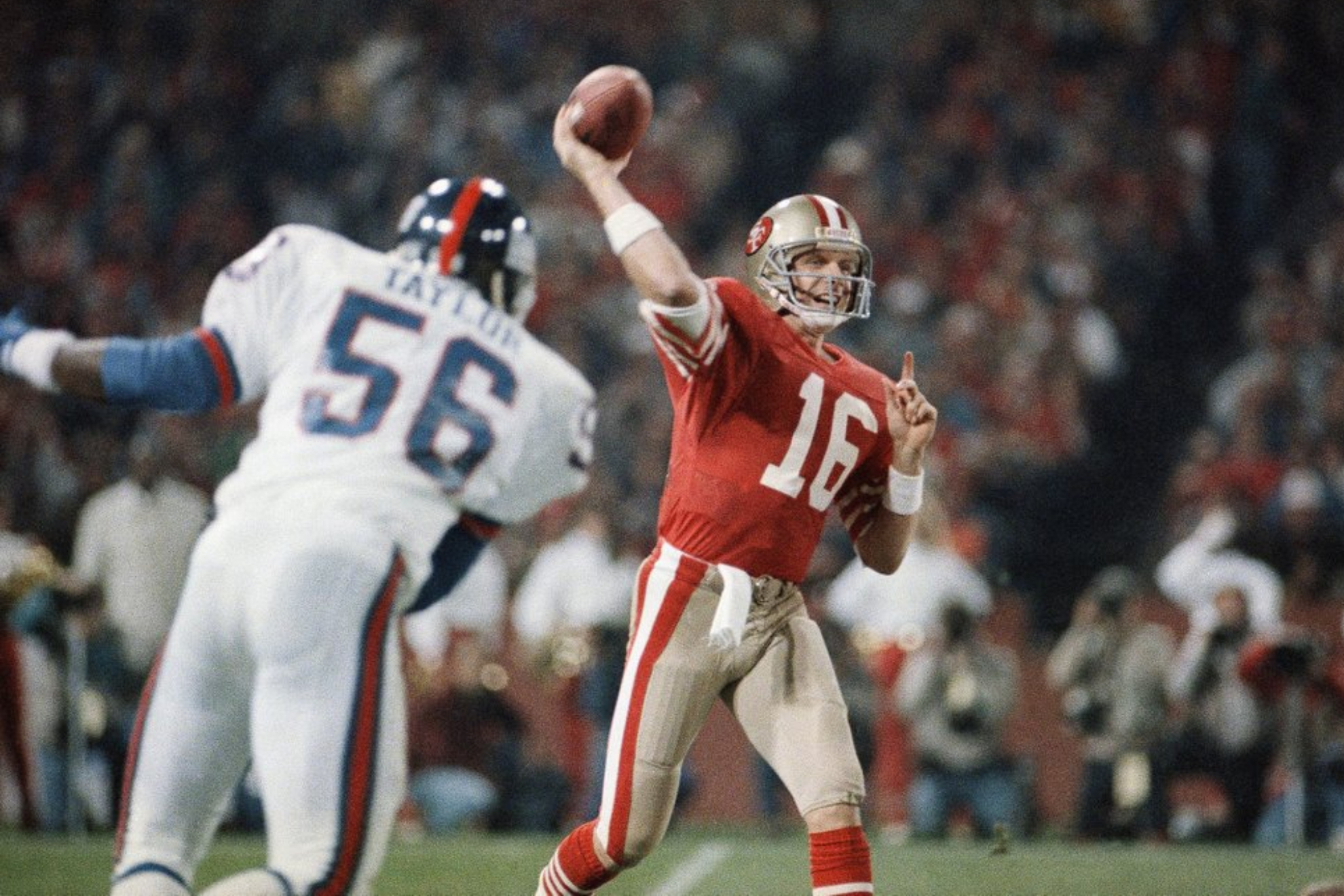 San Francisco 49ers quarterback Joe Montana passing before New York Giants linebacker Lawrence Taylor.