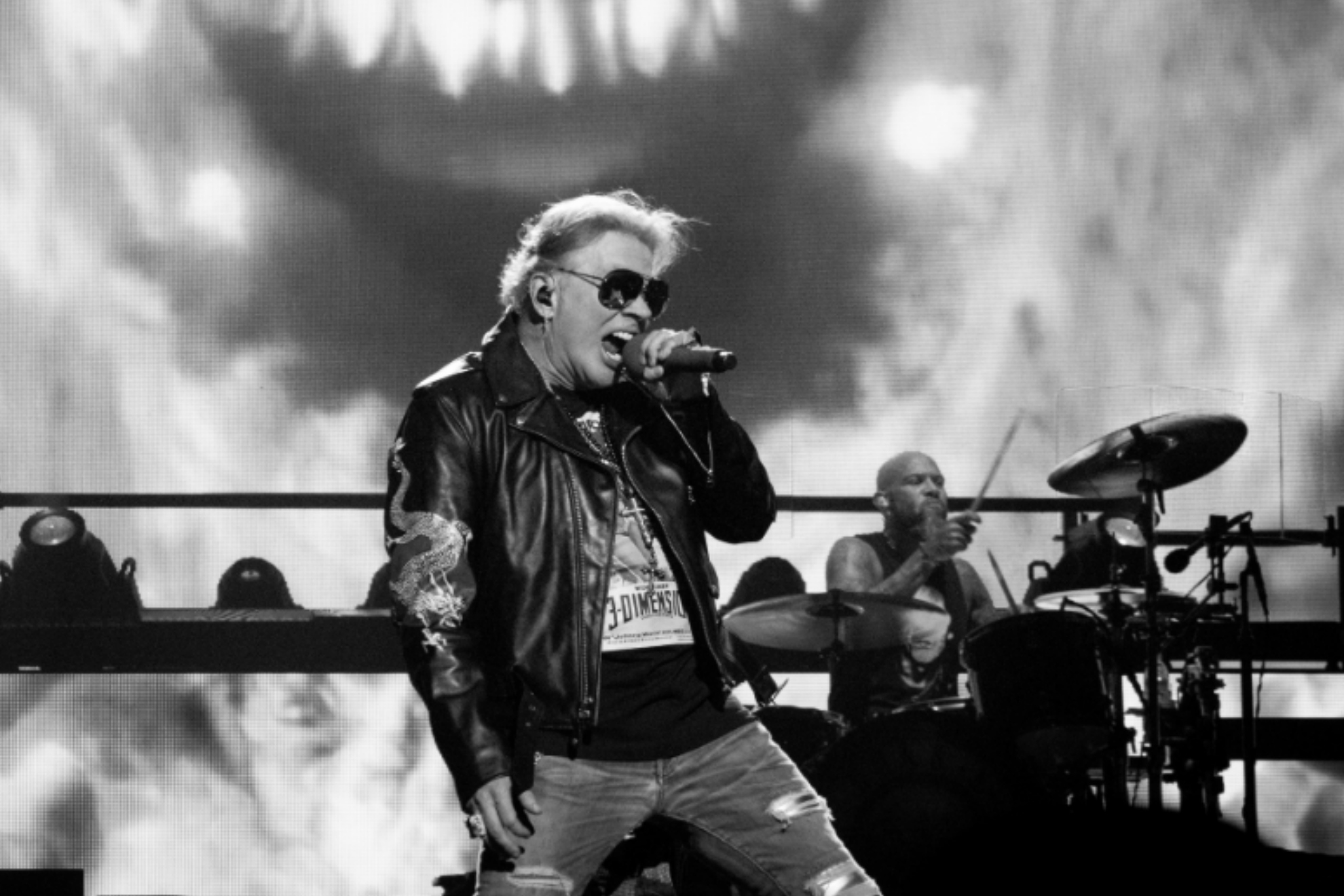 Guns N' Roses' Axl Rose throws a microphone during concert to hit a drone, leaves a woman in a bloody mess