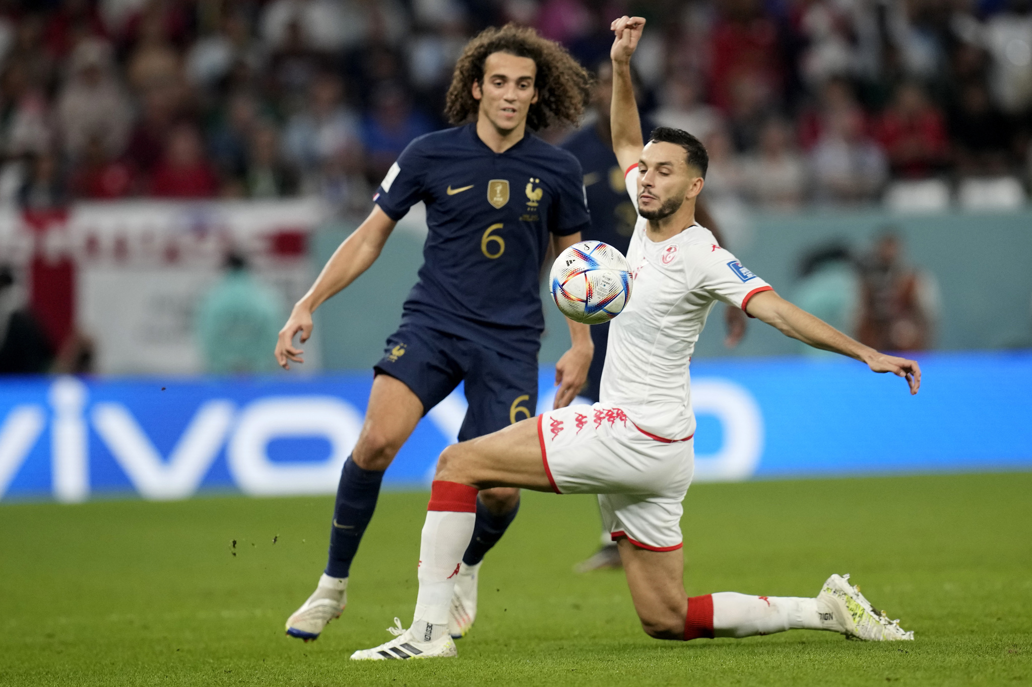 France's Matteo  lt;HIT gt;Guendouzi lt;/HIT gt; , left, watches Tunisia's Montassar Talbi controlling the ball during the World Cup group D soccer match between Tunisia and France at the Education City Stadium in Al Rayyan , Qatar, Wednesday, Nov. 30, 2022. (AP Photo/Christophe Ena)