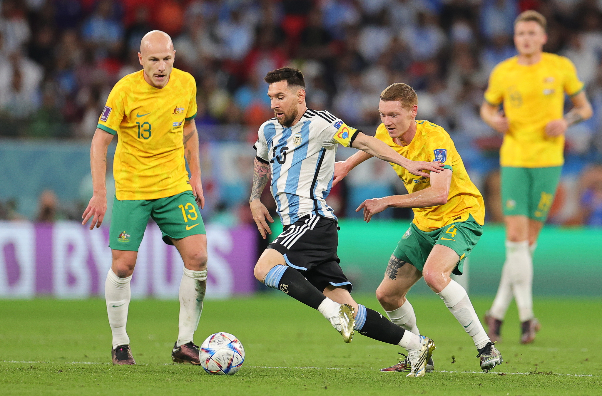 Lionel Messi (2-L) of Argentina  in action against Australian players Aaron Mooy (L) and Kye Rowles (2-R) 