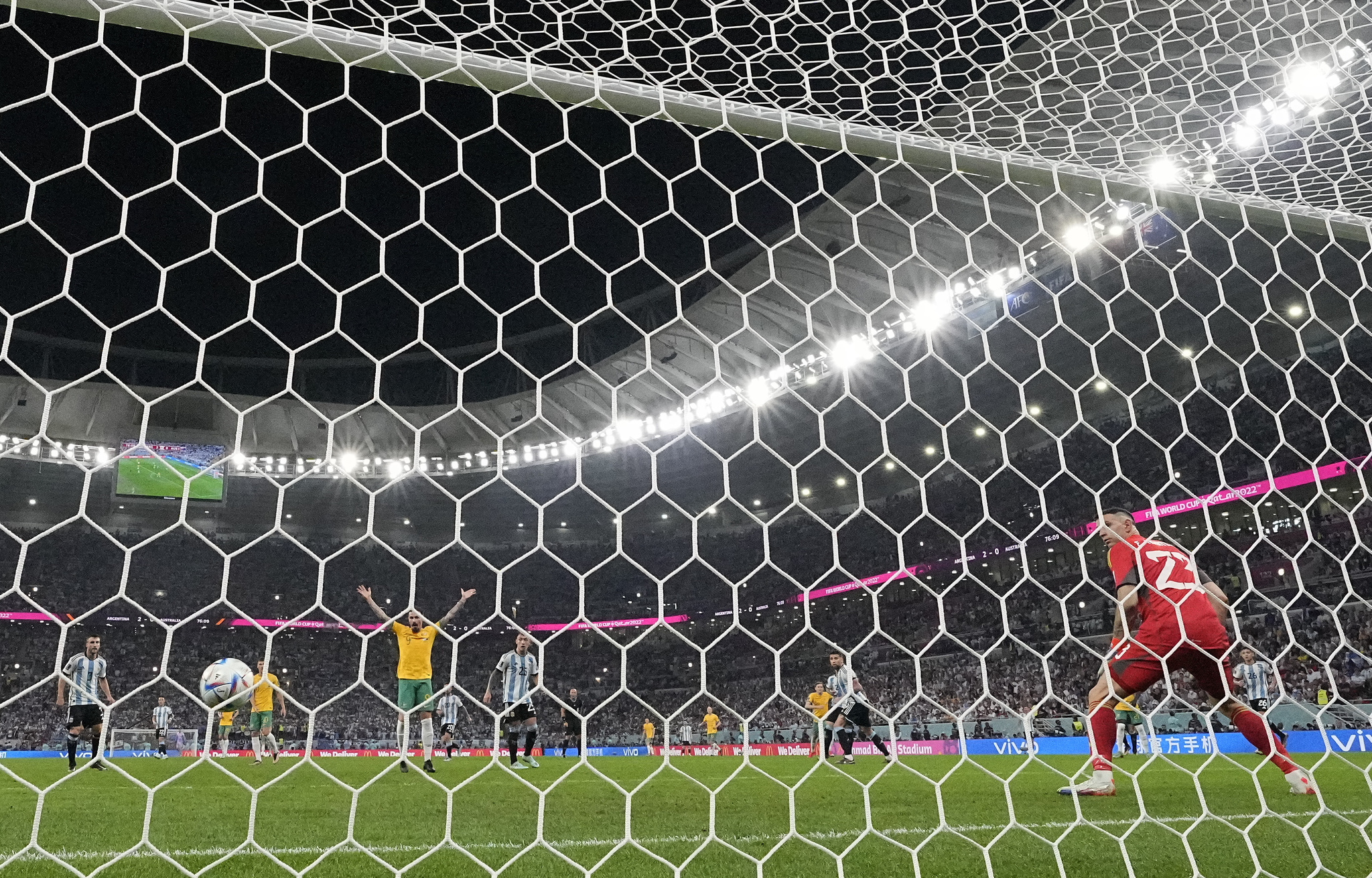 Argentina's goalkeeper Emiliano Martinez looks on as a deflected shot fromAustralia's Craig Goodwin goes into the net 