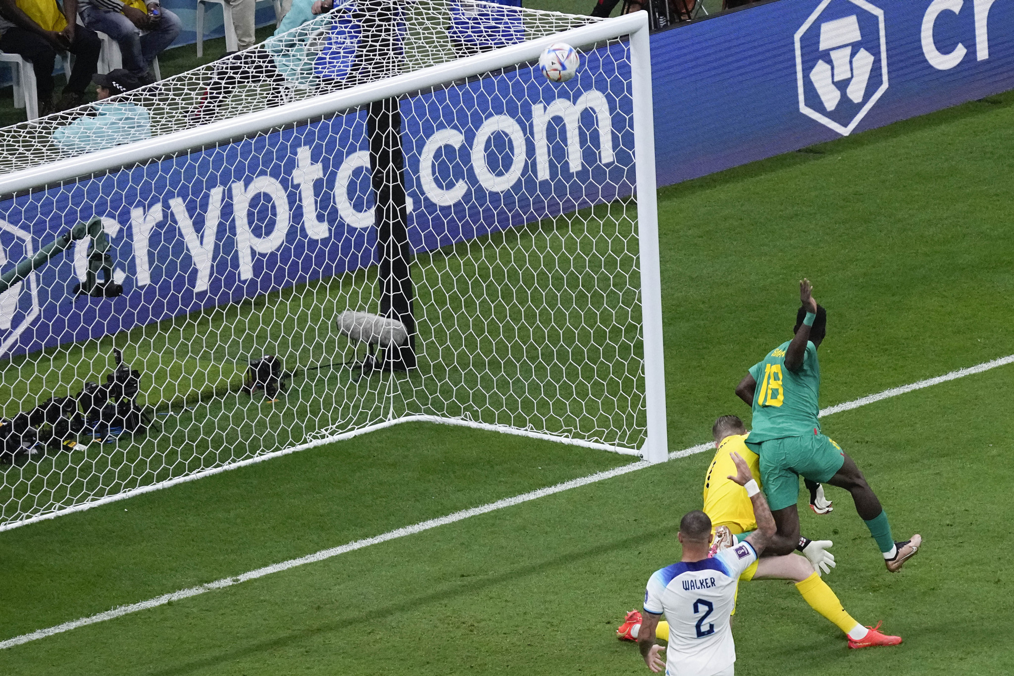 England goalkeeper Jordan Pickford, left, and Senegal's Ismaila Sarr vie for the ball 