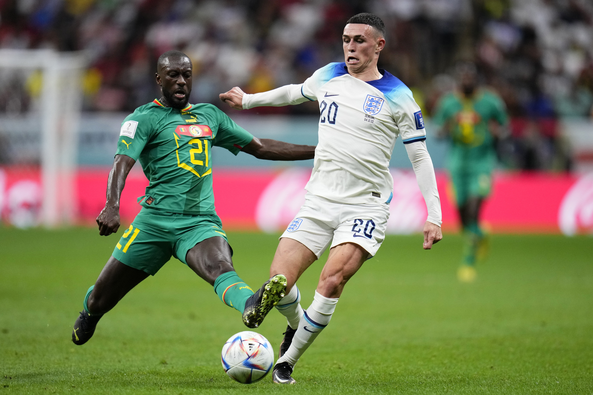 Senegal's Youssouf Sabali, left, tries to tackle Phil Foden 
