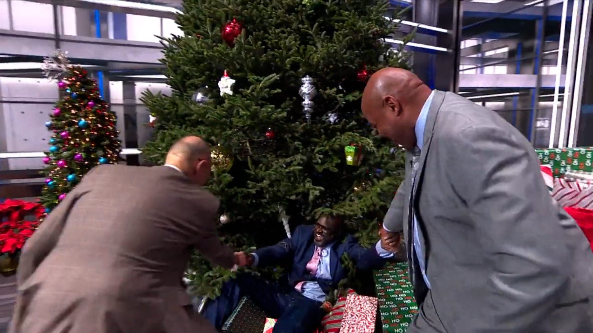 Shaquille O'Neal shoved into a giant Christmas tree by Kenny Smith live on TV