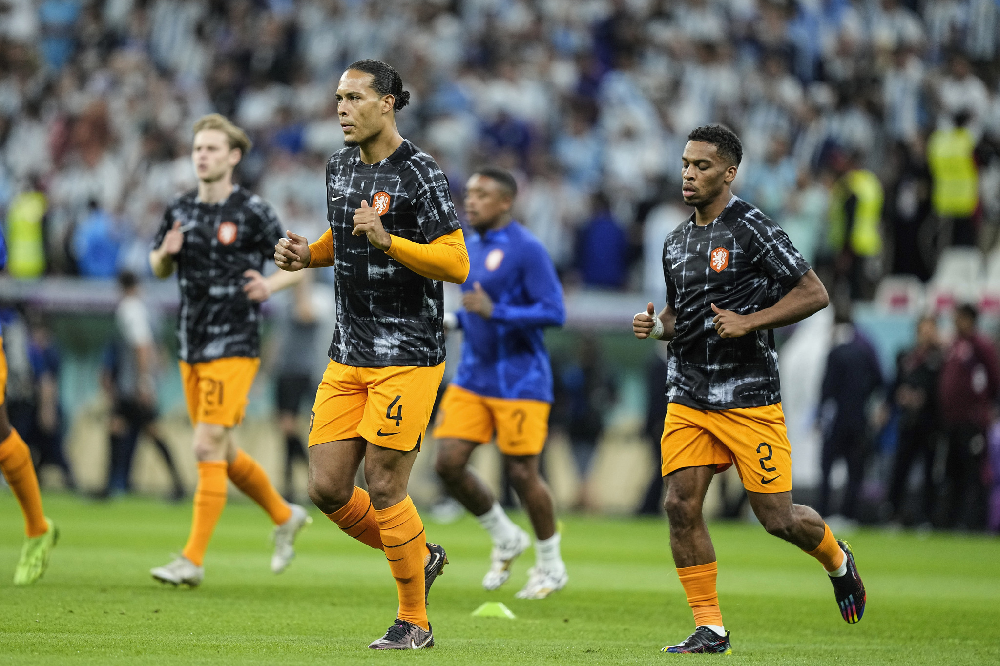 Virgil van Dijk of the Netherlands, left, and his teammate Jurrien Timber warm up prior the start of the World Cup quarterfinal soccer match between the Netherlands and  lt;HIT gt;Argentina lt;/HIT gt;, at the Lusail Stadium in Lusail, Qatar, Friday, Dec. 9, 2022. (AP Photo/Jorge Saenz)