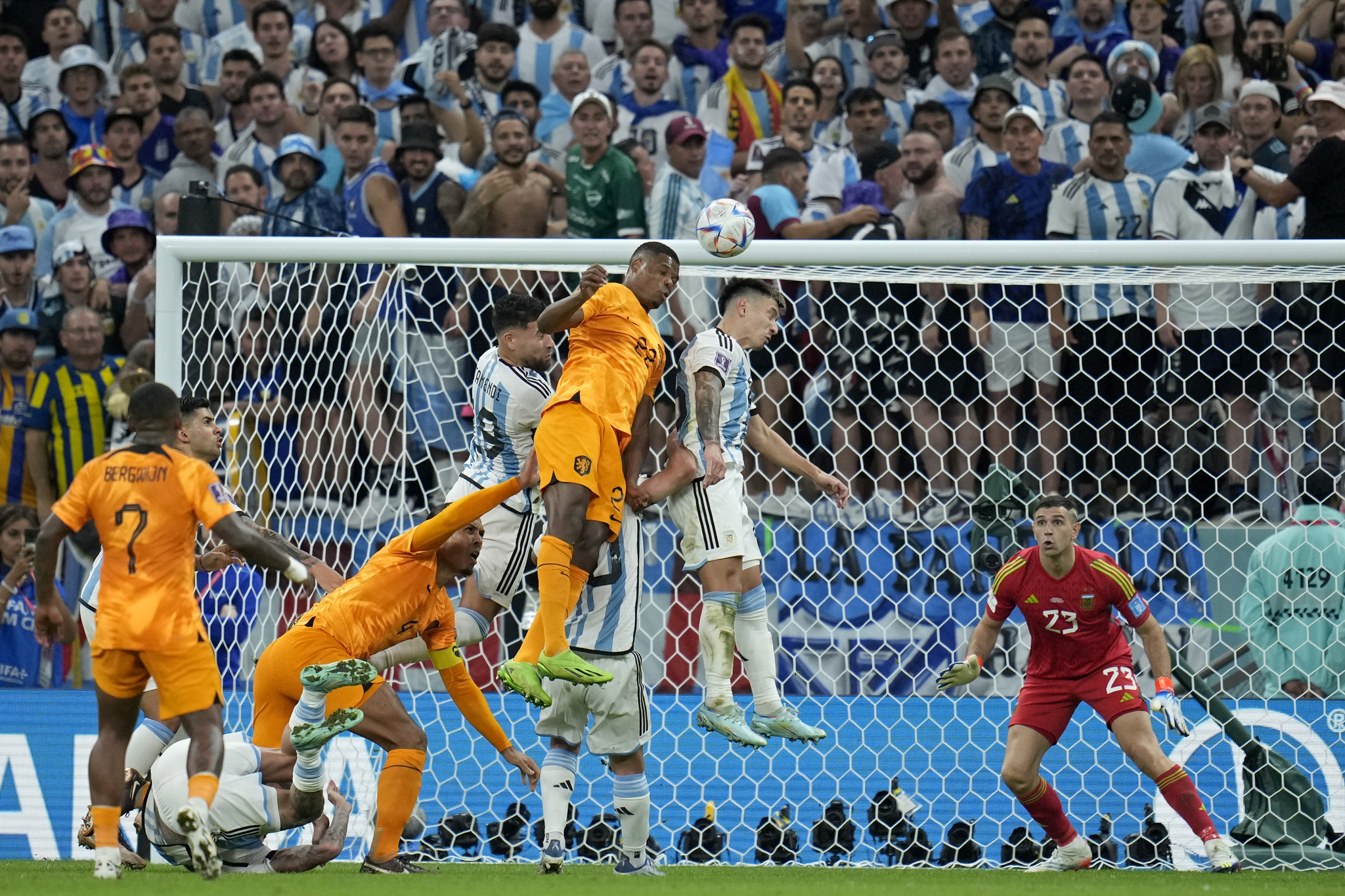  lt;HIT gt;Argentina lt;/HIT gt;'s goalkeeper Emiliano Martinez, right, watches as  lt;HIT gt;Argentina lt;/HIT gt;'s Lisandro Martinez, 2nd right, jumps for the ball with Denzel Dumfries of the Netherlands during the World Cup quarterfinal soccer match between the Netherlands and  lt;HIT gt;Argentina lt;/HIT gt;, at the Lusail Stadium in Lusail, Qatar, Friday, Dec. 9, 2022. (AP Photo/Ricardo Mazalan)