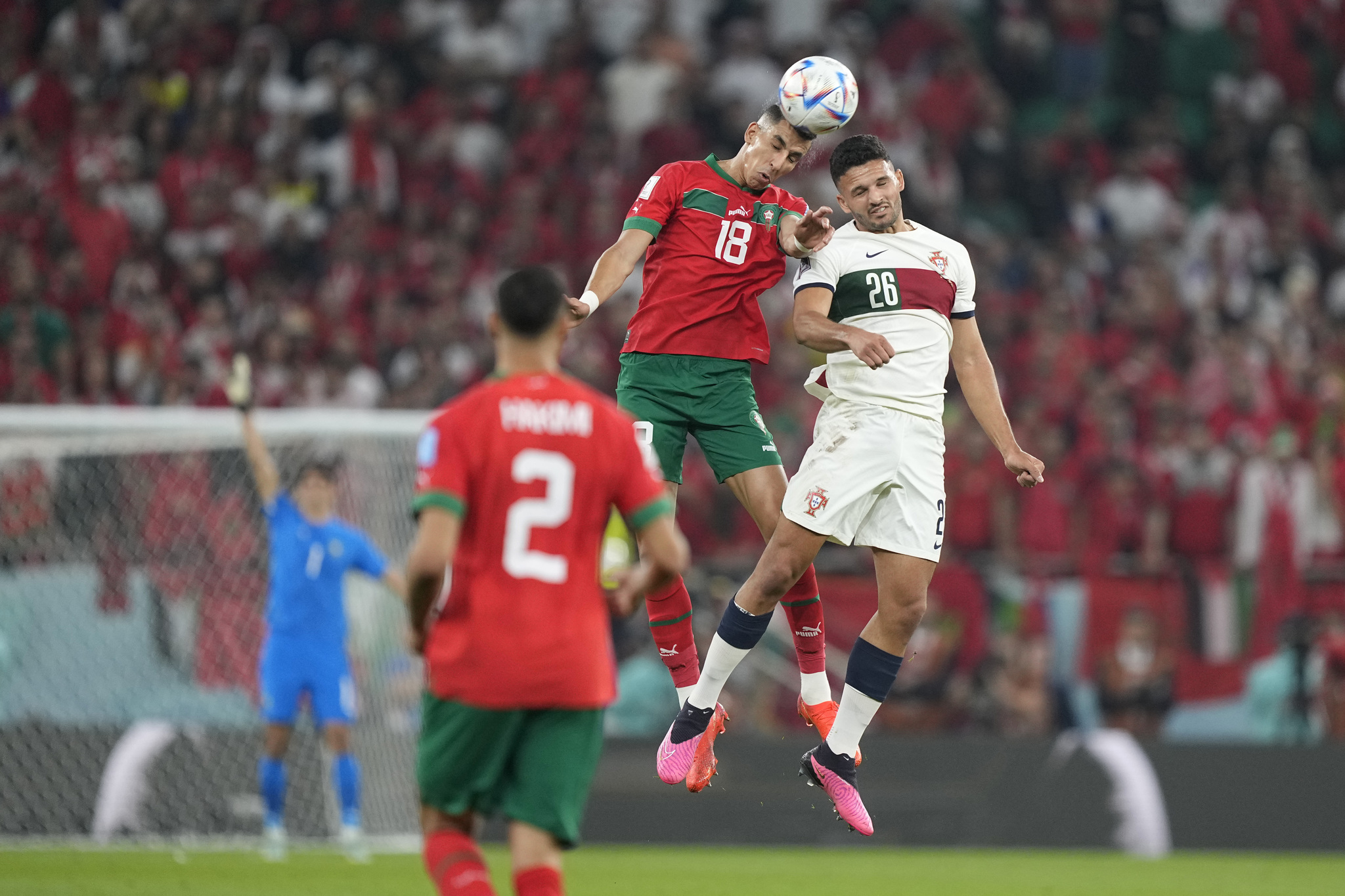 Morocco's Jawad El Yamiq, left, jumps for a header with  lt;HIT gt;Portugal lt;/HIT gt;'s Goncalo Ramos during the World Cup quarterfinal soccer match between Morocco and  lt;HIT gt;Portugal lt;/HIT gt;, at Al Thumama Stadium in Doha, Qatar, Saturday, Dec. 10, 2022. (AP Photo/Martin Meissner)