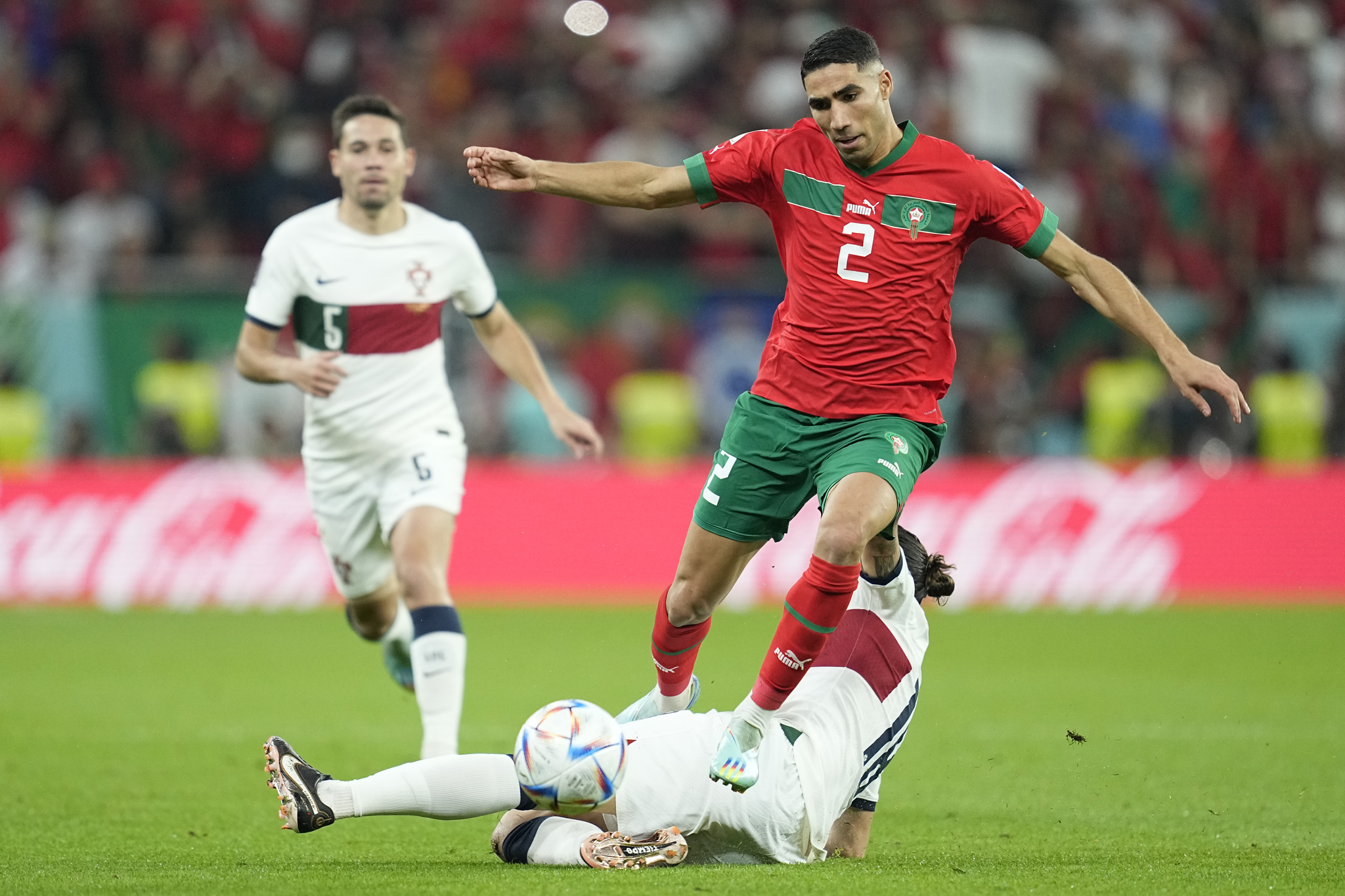  lt;HIT gt;Portugal lt;/HIT gt;'s Bernardo Silva tackles Morocco's Achraf Hakimi during the World Cup quarterfinal soccer match between Morocco and  lt;HIT gt;Portugal lt;/HIT gt;, at Al Thumama Stadium in Doha, Qatar, Saturday, Dec. 10, 2022. (AP Photo/Ebrahim Noroozi)