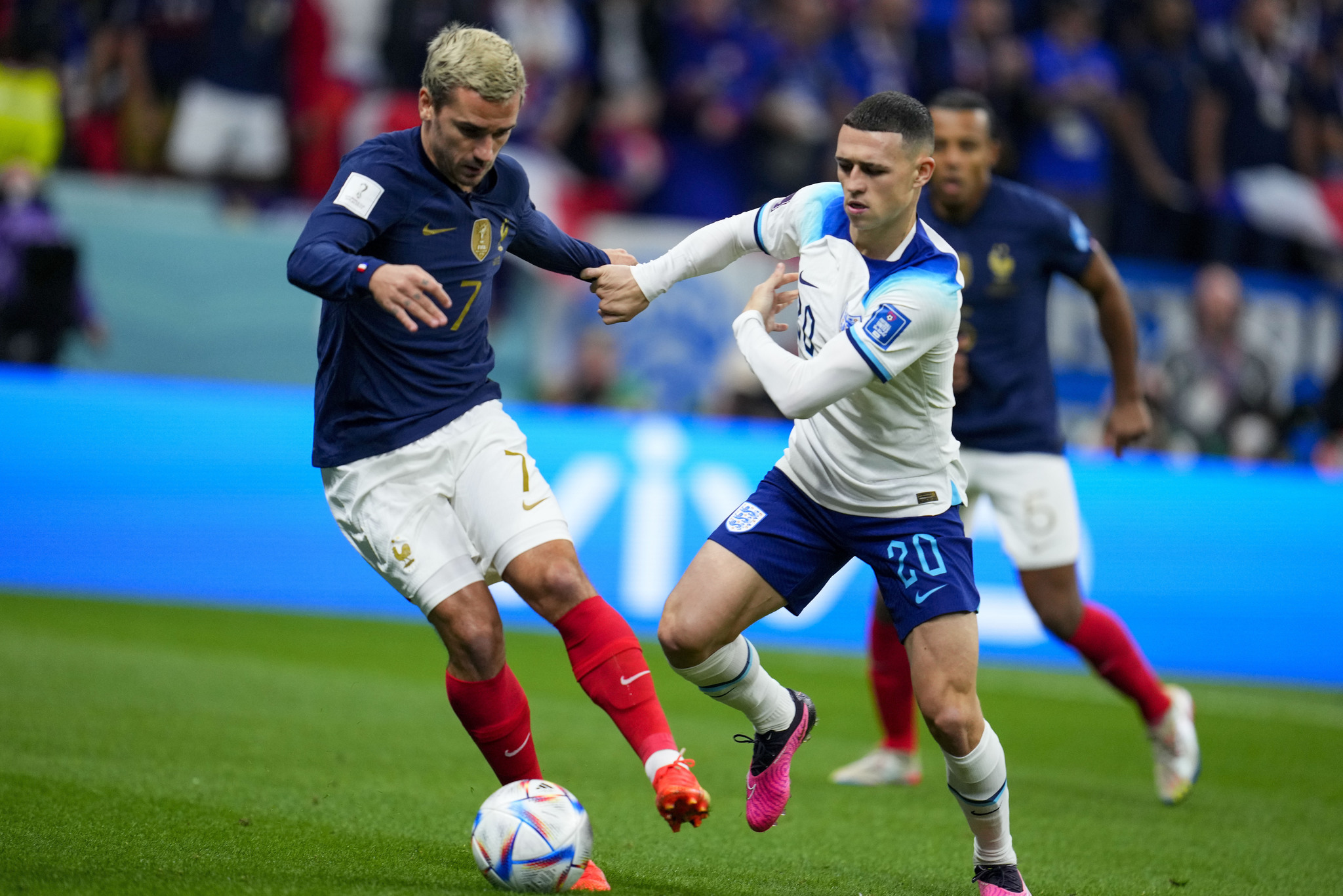 France's Antoine  lt;HIT gt;Griezmann lt;/HIT gt;, left, and England's Phil Foden battle for the ball during the World Cup quarterfinal soccer match between England and France, at the Al Bayt Stadium in Al Khor, Qatar, Saturday, Dec. 10, 2022. (AP Photo/Natacha Pisarenko)