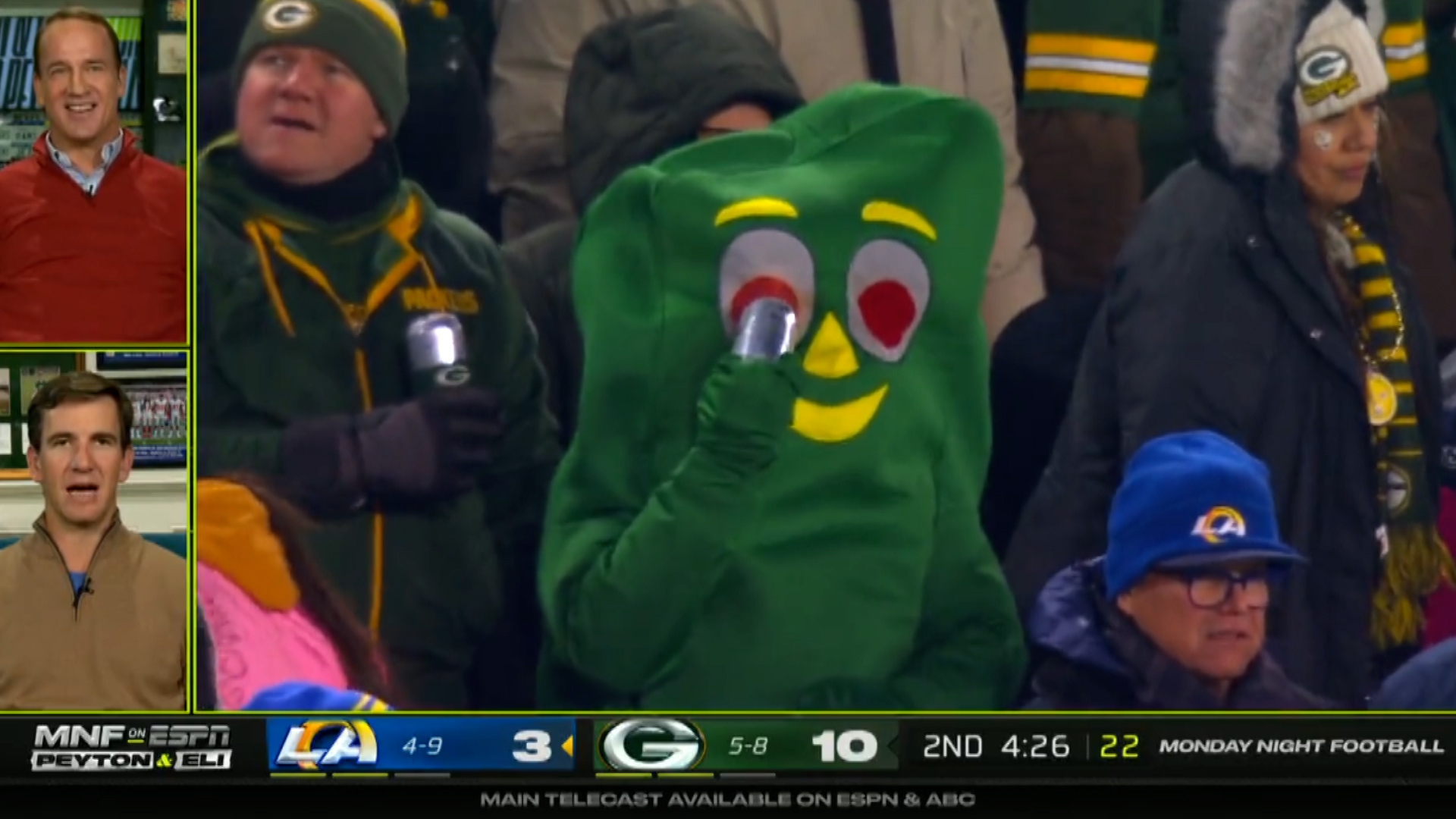 Manning brothers can't control laughter after spotting fan dressed in Gumby suit drinking beer through eye