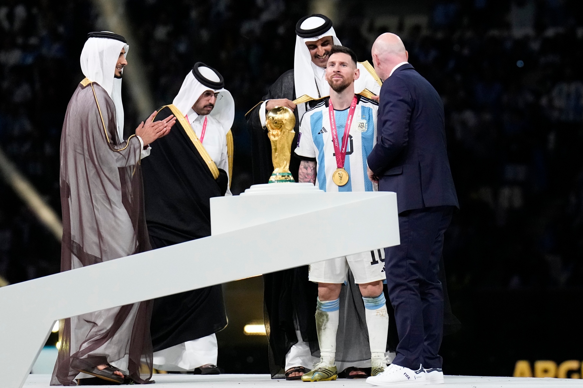 Lionel Messi getting the Bisht from the Emir of Qatar