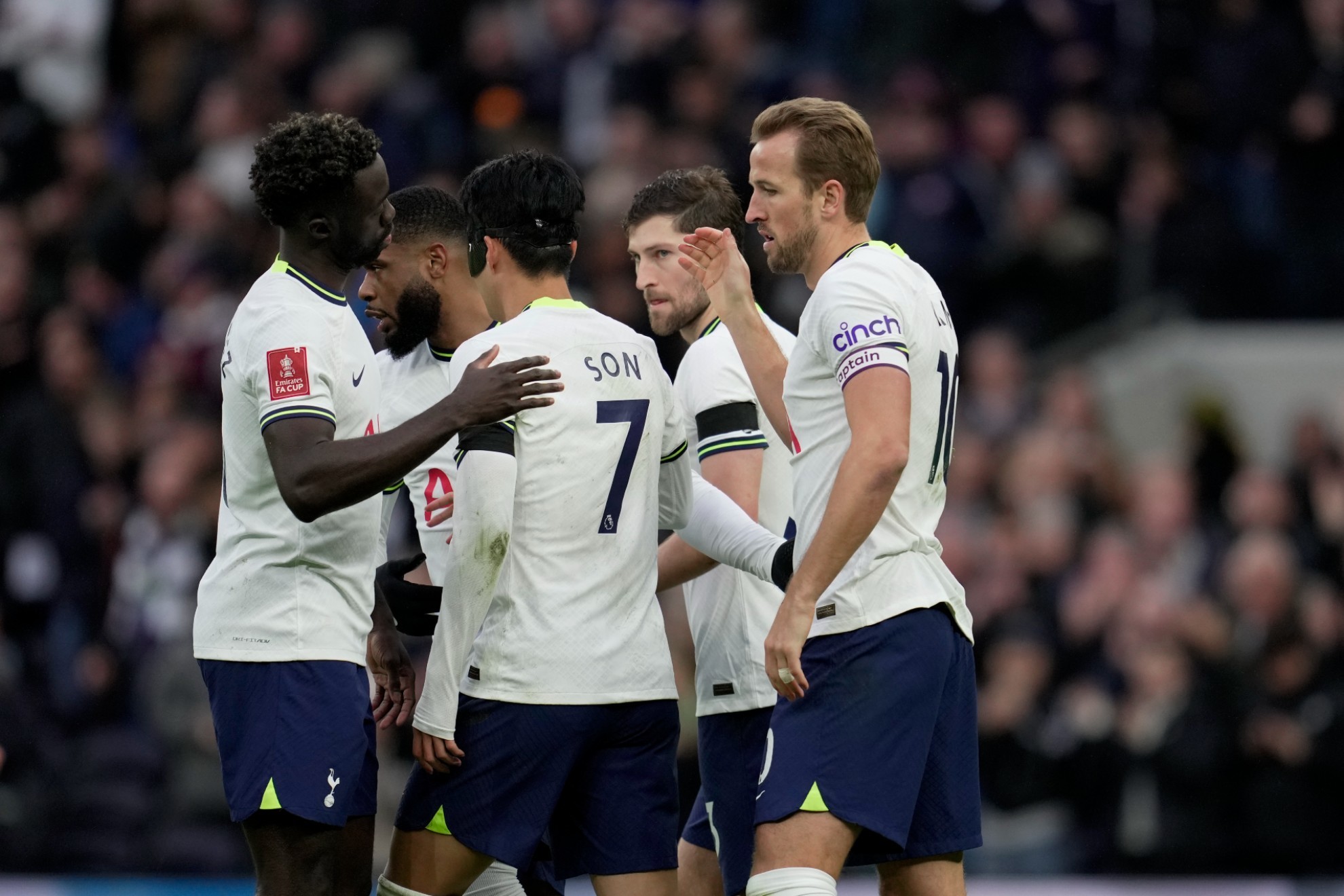 Tottenham's Harry Kane celebrates with teammates after scoring his side's opening goal.