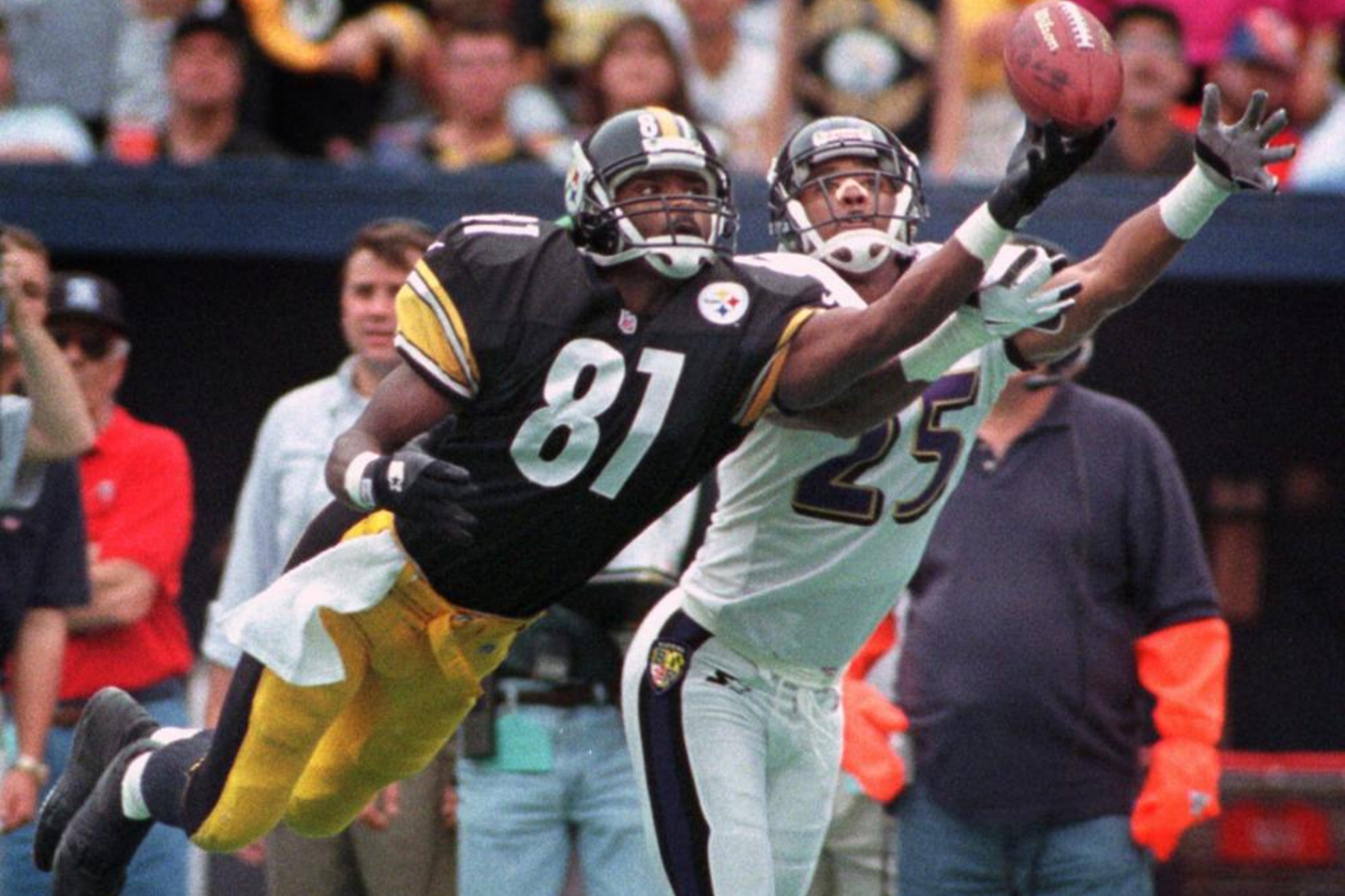 Pittsburgh Steelers WR Charles Johnson dives for a pass as Baltimore Ravens' DeRon Jenkins defends.